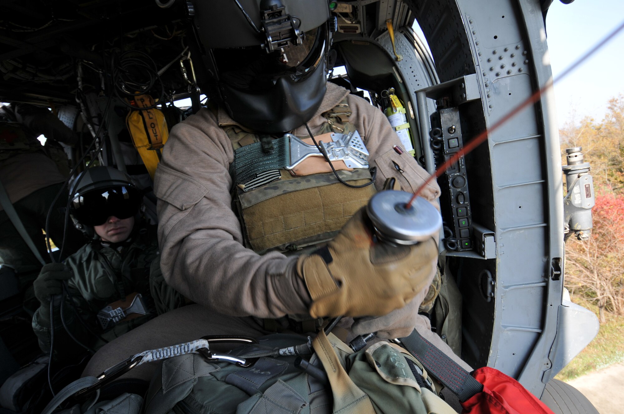 U.S. Air Force Staff Sgt. Brandon Taylor, 33rd Rescue Squadron HH-60G Flight Engineer, from Kadena Air Base, Japan, prepares to hoist gear down from the helicopter during exercise PACIFIC THUNDER Nov. 1, 2011 near Osan Air Base, Korea.

PACIFIC THUNDER is a 10-day exercise, from Oct. 31-Nov. 09, at Osan AB, Korea involving the 33rd Rescue Squadron, Kadena AB, Japan, and the 25th Fighter Squadron, Osan AB, Korea. These units work together to practice Combat Search and Rescue tactics to prepare for real-world emergency situations. 
(U.S. Air Force photo/Tech. Sgt. Angelique Bilog/released)

