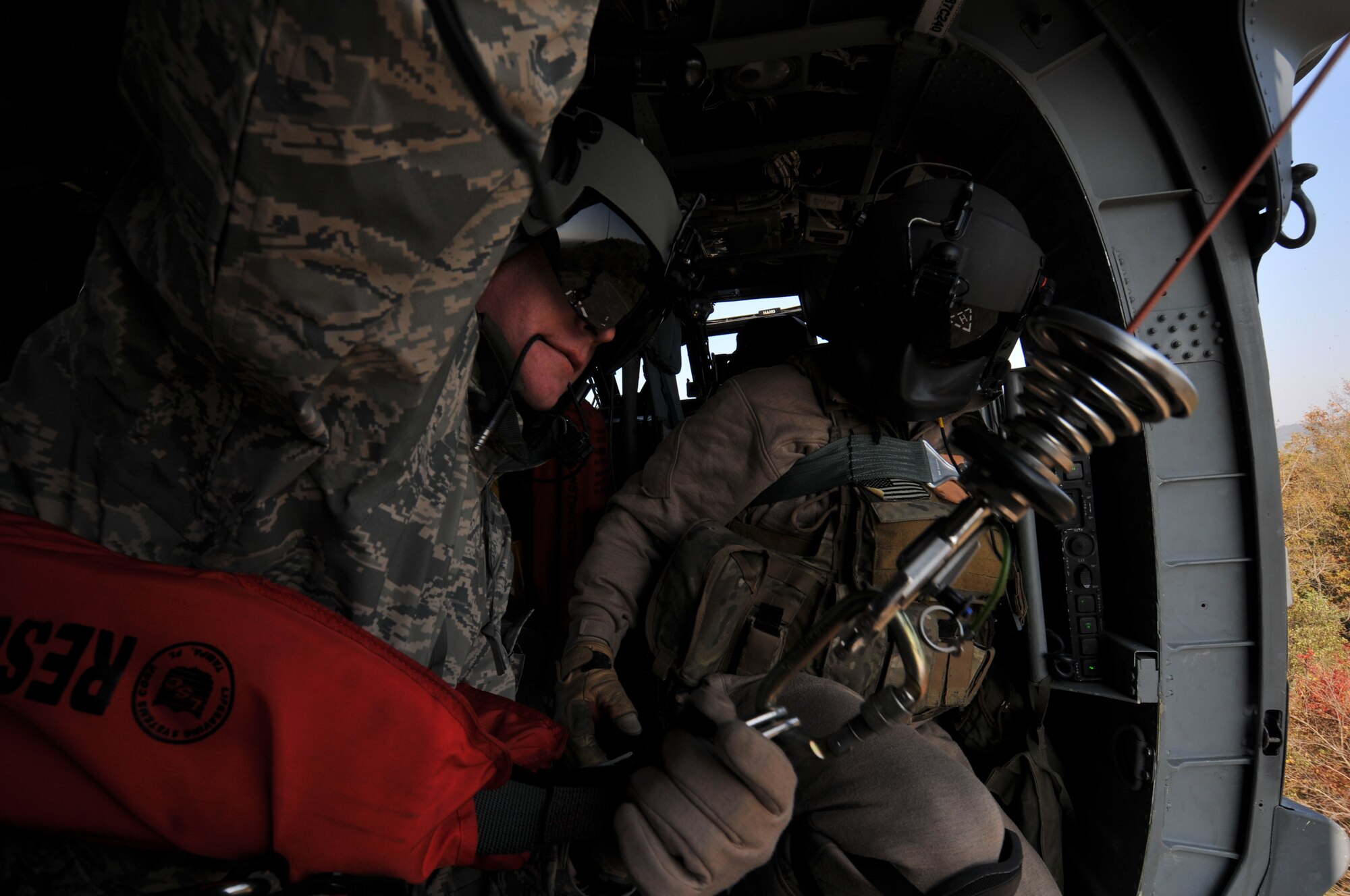 U.S. Air Force Tech. Sgt. Heath Culbertson, 33rd Rescue Squadron HH-60G Flight Engineer, prepares to be hoisted from the helicopter to the ground with the help of 33rd RQS Flight Engineer, U.S. Air Force Staff Sgt. Brandon Taylor, both from Kadena Air Base, Japan during exercise PACIFIC THUNDER Nov. 1, 2011 near Osan Air Base, Korea.

PACIFIC THUNDER is a 10-day exercise, from Oct. 31-Nov. 09, at Osan AB, Korea involving the 33rd Rescue Squadron, Kadena AB, Japan, and the 25th Fighter Squadron, Osan AB, Korea. These units work together to practice Combat Search and Rescue tactics to prepare for real-world emergency situations. 
(U.S. Air Force photo/Tech. Sgt. Angelique Bilog/released)
