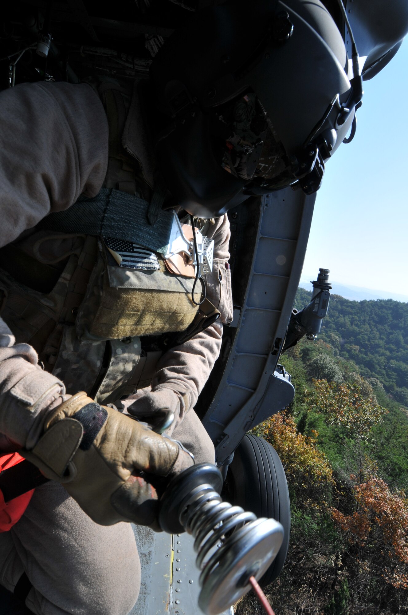 U.S. Air Force Staff Sgt. Brandon Taylor, 33rd Rescue Squadron HH-60G Flight Engineer, from Kadena Air Base, Japan, hoists gear down from the helicopter during exercise PACIFIC THUNDER Nov. 1, 2011 near Osan Air Base, Korea.

PACIFIC THUNDER is a 10-day exercise, from Oct. 31-Nov. 09, at Osan AB, Korea involving the 33rd Rescue Squadron, Kadena AB, Japan, and the 25th Fighter Squadron, Osan AB, Korea. These units work together to practice Combat Search and Rescue tactics to prepare for real-world emergency situations. 
(U.S. Air Force photo/Tech. Sgt. Angelique Bilog/released)

