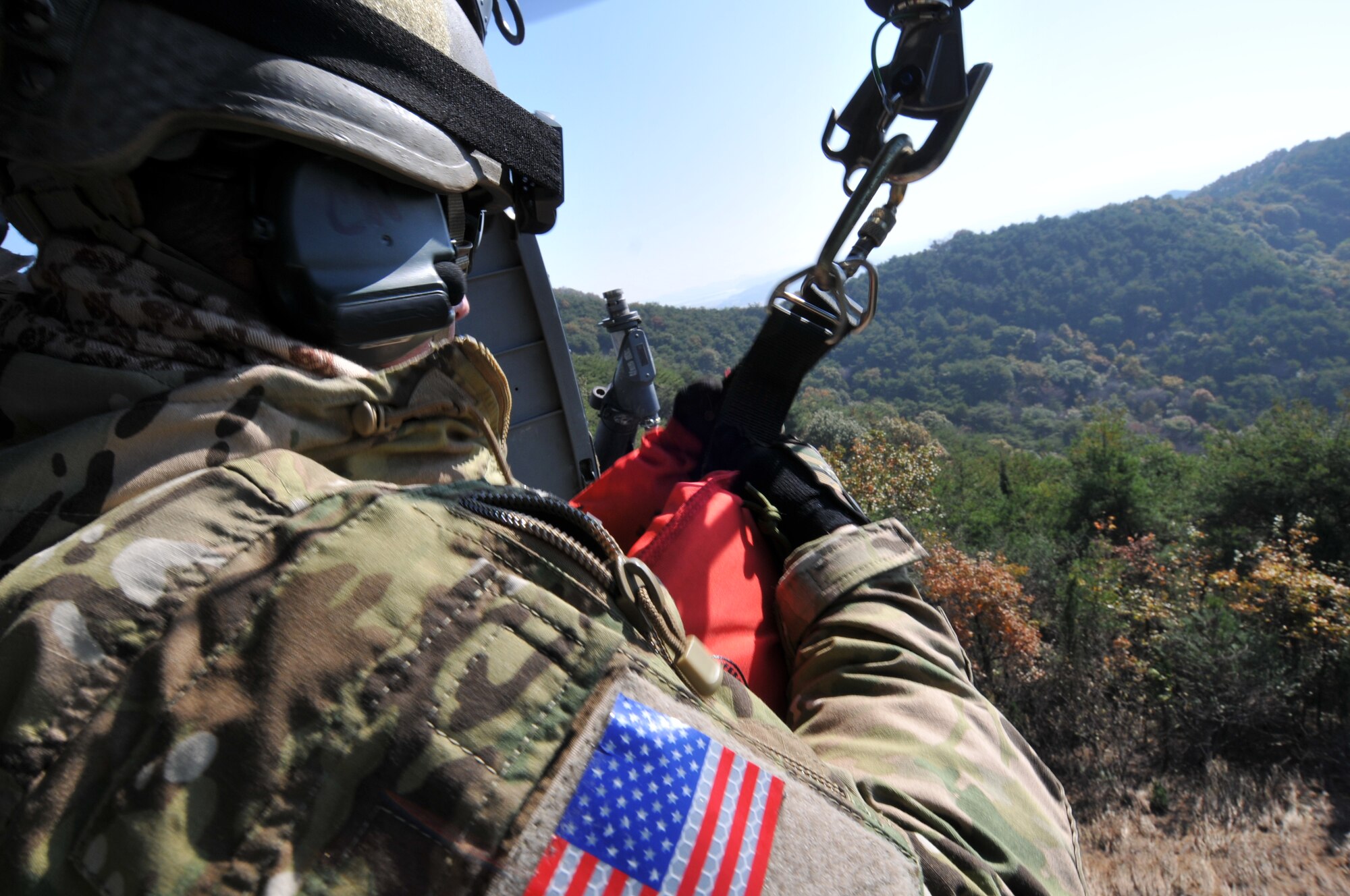 U.S. Air Force Staff Sgt. Robert Colliton, Survival Evasion Resistance Escape Specialist at the 18th Operation Support Squadron, Kadena Air Base, Japan, prepares to be hoisted from the helicopter to the ground during exercise PACIFIC THUNDER Nov. 1, 2011 near Osan Air Base, Korea.

PACIFIC THUNDER is a 10-day exercise, from Oct. 31-Nov. 09, at Osan AB, Korea involving the 33rd Rescue Squadron, Kadena AB, Japan, and the 25th Fighter Squadron, Osan AB, Korea. These units work together to practice Combat Search and Rescue tactics to prepare for real-world emergency situations. 
(U.S. Air Force photo/Tech. Sgt. Angelique Bilog/released)
