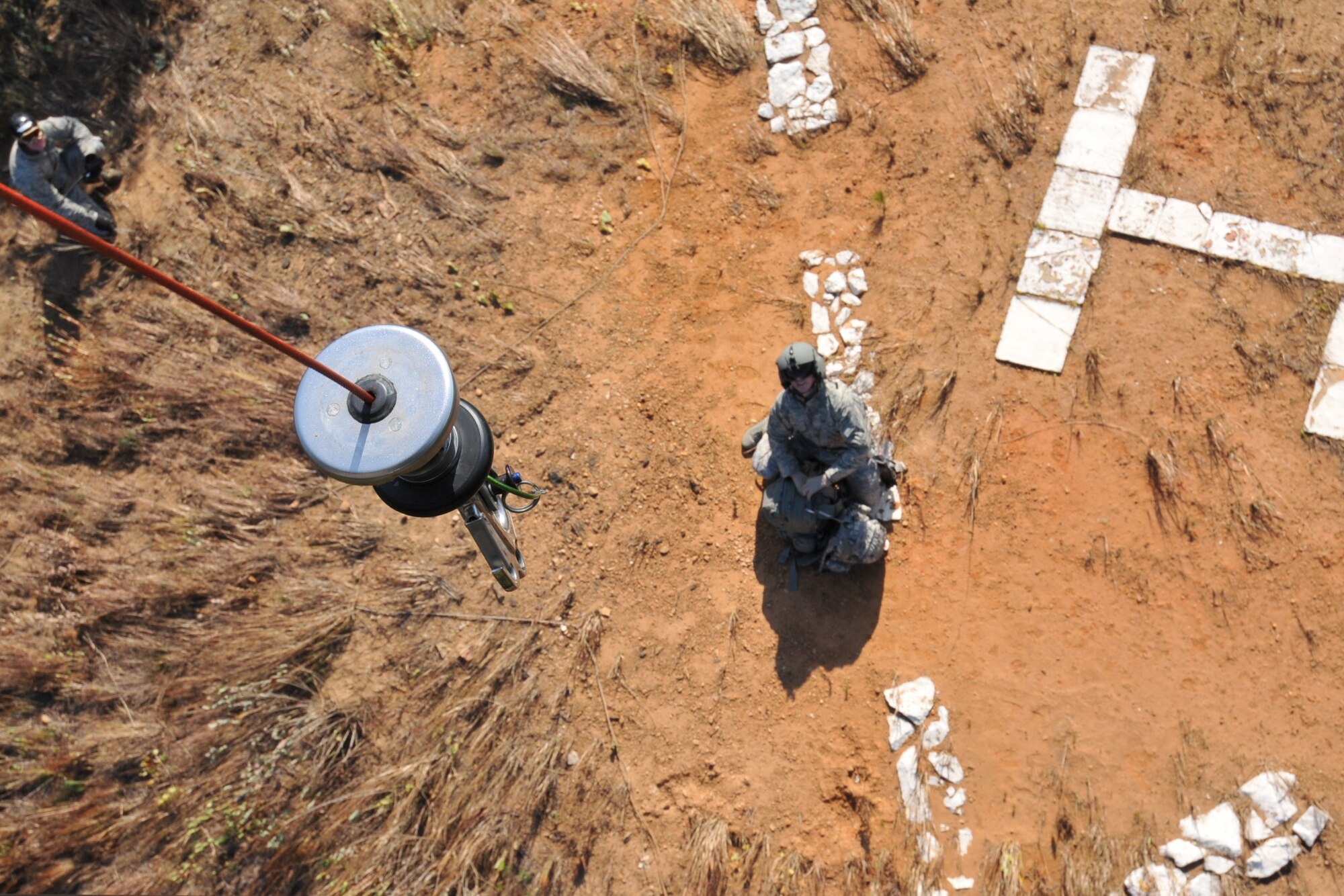 U.S. Air Force Tech. Sgt. Heath Culbertson, 33rd Rescue Squadron HH-60G Flight Engineer, Kadena Air Base, Japan, prepares to hoist gear up to the helicopter during exercise PACIFIC THUNDER Nov. 1, 2011 near Osan Air Base, Korea.

PACIFIC THUNDER is a 10-day exercise, from Oct. 31-Nov. 09, at Osan AB, Korea involving the 33rd Rescue Squadron, Kadena AB, Japan, and the 25th Fighter Squadron, Osan AB, Korea. These units work together to practice Combat Search and Rescue tactics to prepare for real-world emergency situations. 
(U.S. Air Force photo/Tech. Sgt. Angelique Bilog/released)
