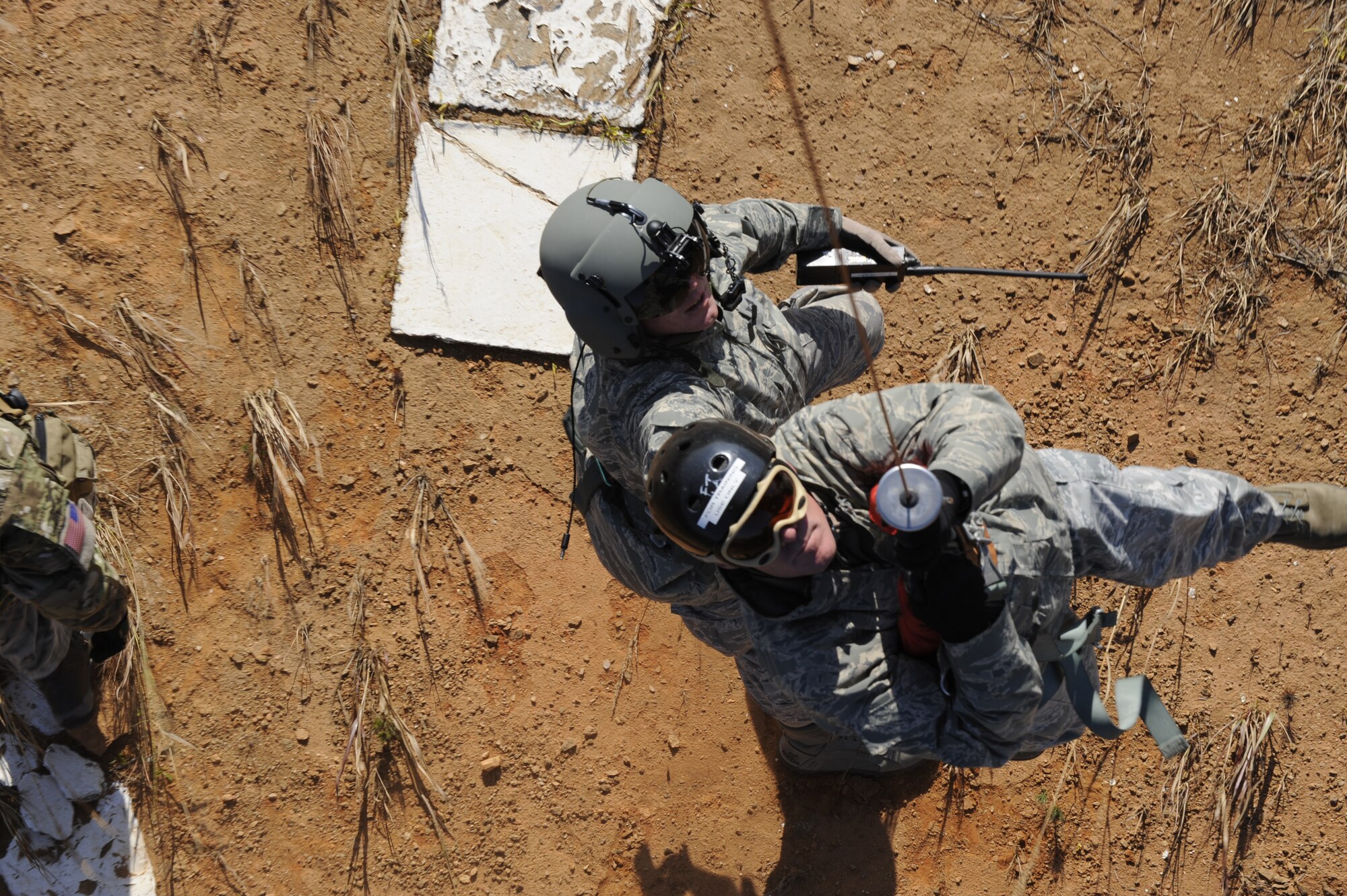 U.S. Air Force Tech. Sgt. Heath Culbertson, 33rd Rescue Squadron HH-60G Flight Engineer, assists U.S. Air Force Chief Master Sgt. Jeremy Ravlin, 33rd Helicopter Maintenance Unit, both from Kadena Air Base, Japan, in hoisting up to the helicopter during exercise PACIFIC THUNDER Nov. 1, 2011 near Osan Air Base, Korea.


PACIFIC THUNDER is a 10-day exercise, from Oct. 31-Nov. 09, at Osan AB, Korea involving the 33rd Rescue Squadron, Kadena AB, Japan, and the 25th Fighter Squadron, Osan AB, Korea. These units work together to practice Combat Search and Rescue tactics to prepare for real-world emergency situations. 
(U.S. Air Force photo/Tech. Sgt. Angelique Bilog/released)
