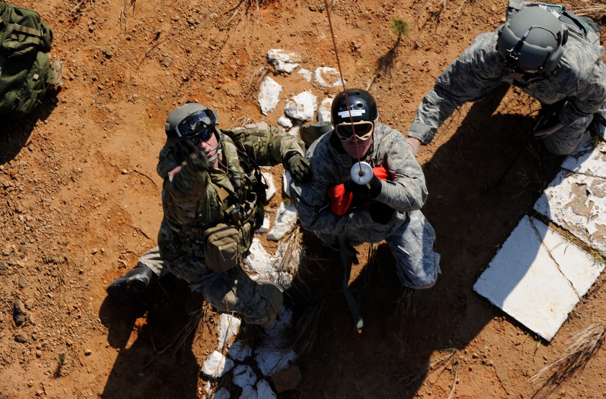U.S. Air Force Staff Sgt. Robert Colliton, Survival Evasion Resistance Escape Specialist at the 18th Operation Support Squadron, and U.S. Air Force Tech. Sgt. Heath Culbertson, 33rd Rescue Squadron HH-60G Flight Engineer, prepare U.S. Air Force Chief Master Sgt. Jeremy Ravlin, 33rd Helicopter Maintenance Unit, all from Kadena Air Base, Japan, to hoist up to the helicopter during exercise PACIFIC THUNDER Nov. 1, 2011 near Osan Air Base, Korea.

PACIFIC THUNDER is a 10-day exercise, from Oct. 31-Nov. 09, at Osan AB, Korea involving the 33rd Rescue Squadron, Kadena AB, Japan, and the 25th Fighter Squadron, Osan AB, Korea. These units work together to practice Combat Search and Rescue tactics to prepare for real-world emergency situations. 
(U.S. Air Force photo/Tech. Sgt. Angelique Bilog/released)
