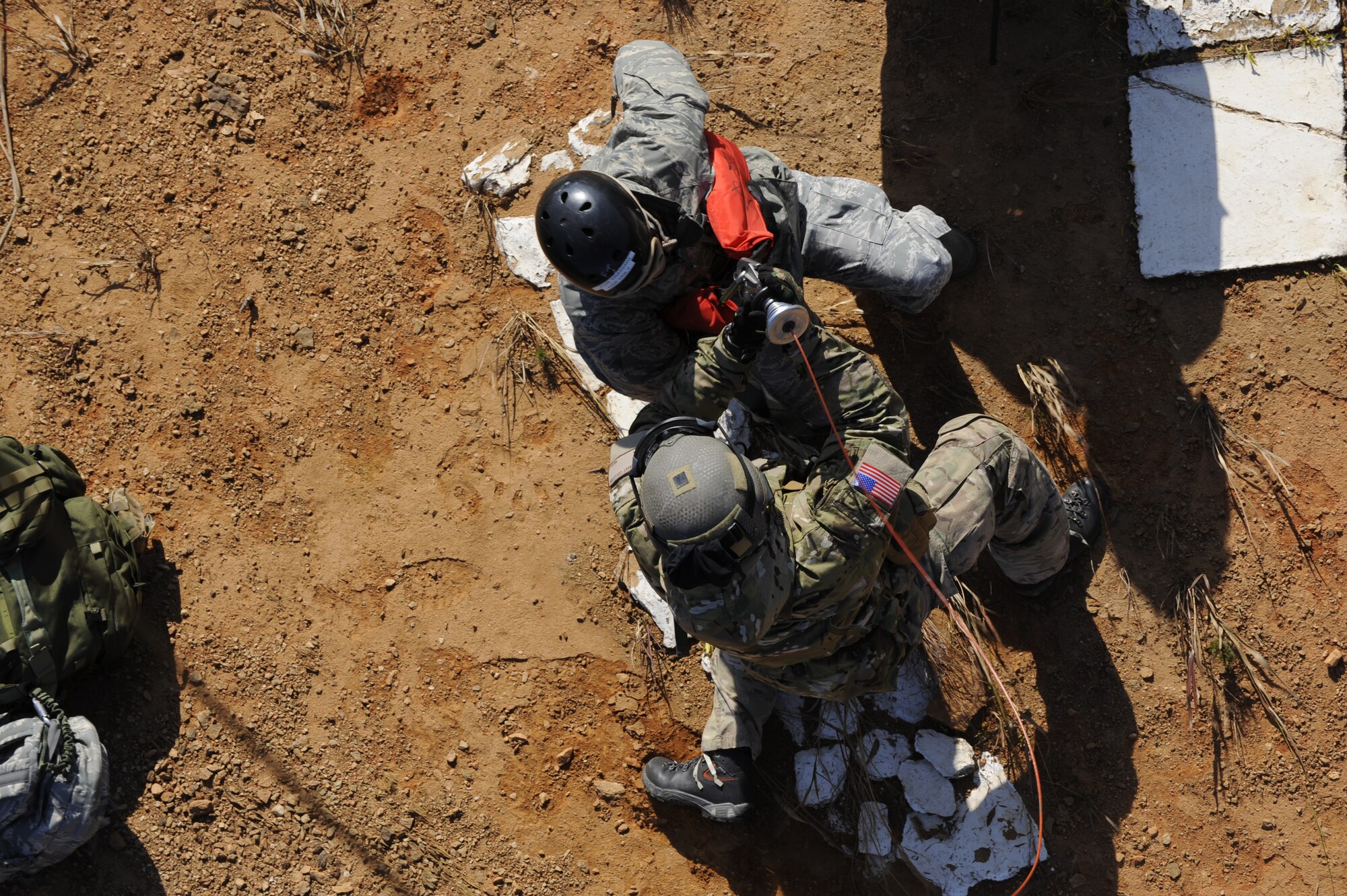 U.S. Air Force Staff Sgt. Robert Colliton, Survival Evasion Resistance Escape Specialist at the 18th Operation Support Squadron, prepares U.S. Air Force Chief Master Sgt. Jeremy Ravlin, 33rd Helicopter Maintenance Unit, both from Kadena Air Base, Japan, to hoist up to the helicopter during exercise PACIFIC THUNDER Nov. 1, 2011 near Osan Air Base, Korea.

PACIFIC THUNDER is a 10-day exercise, from Oct. 31-Nov. 09, at Osan AB, Korea involving the 33rd Rescue Squadron, Kadena AB, Japan, and the 25th Fighter Squadron, Osan AB, Korea. These units work together to practice Combat Search and Rescue tactics to prepare for real-world emergency situations. 
(U.S. Air Force photo/Tech. Sgt. Angelique Bilog/released)
