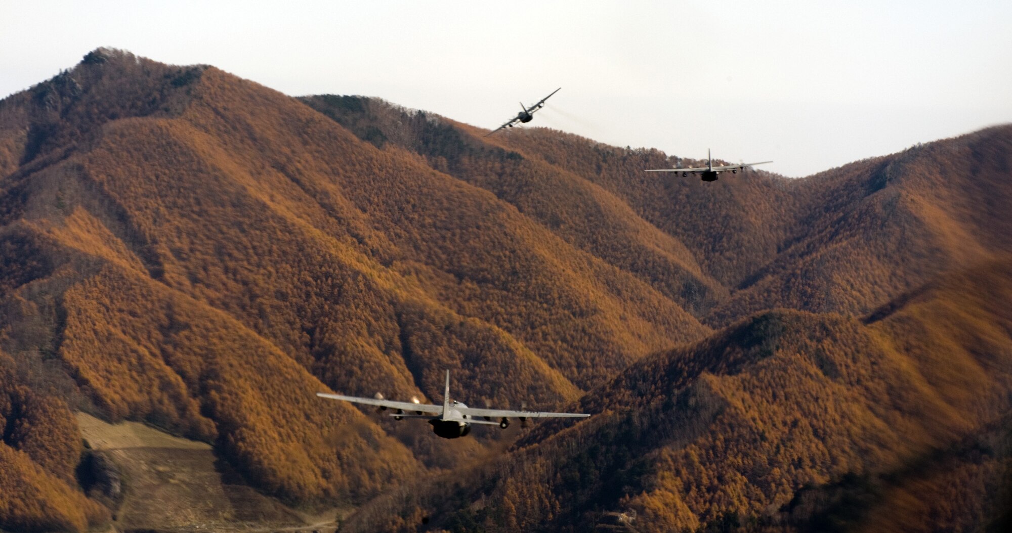 OVER JAPAN -- Three C-130 Hercules fly in a formation during a Samurai Surge over Japan, Nov. 2, 2011. Aircraft from Yokota Air Base practiced flying in formation and airdrop skills. (U.S. Air Force photo/Airman 1st Class Krystal M. Garrett)