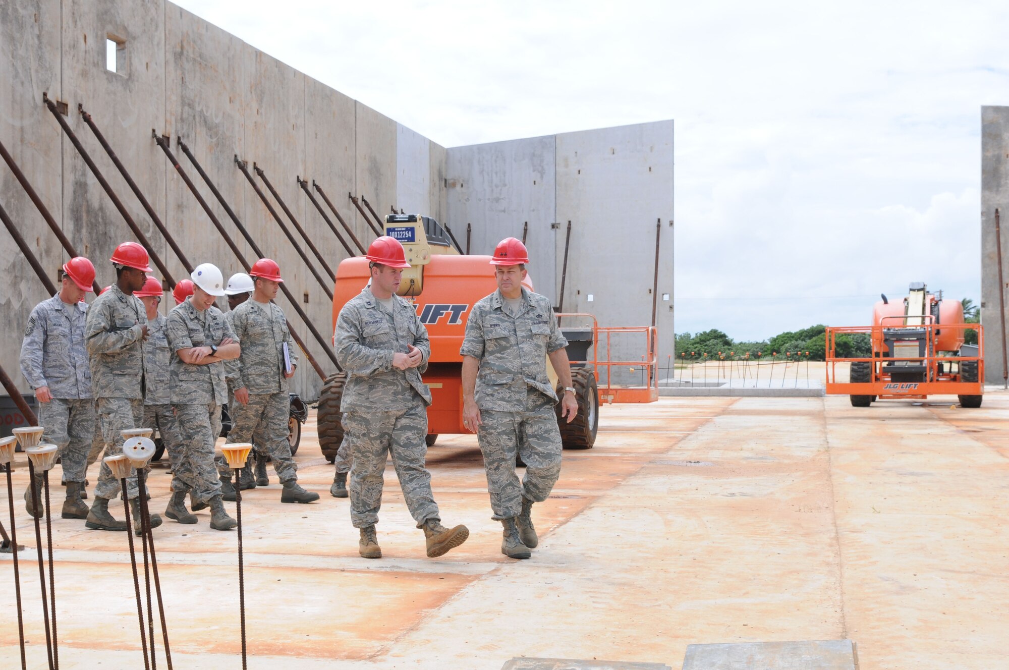 ANDERSEN AIR FORCE BASE, Guam – Capt. Adam Burwinkle (left center), 554th RED HORSE Squadron officer in charge of construction, briefs Maj. Gen. Timothy Byers (right), Air Force Civil Engineer, Headquarters U.S. Air Force, Oct. 30 on North-West Field construction programs in the vertical capabilities warehouse. North-West Field will house the PACAF Regional Training Center which will house Commando Warrior training and Silver Flag training. (U.S. Air Force photo/ Senior Airman Carlin Leslie)