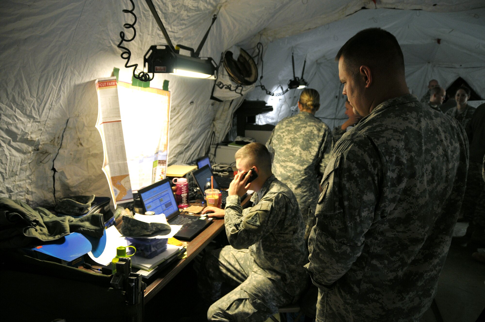 Lt. Joshua Leard from the 1048th Medium Truck Co. and Sgt. 1st Class Damon Matus from the 169th Regiment, regional training institute, go over the process of keeping track of what supply trucks have deployed to Connecticut locations to deliver cases of meals-ready-to-eat and water Nov. 1, 2011. The two Soldiers from the Connecticut Army National Guard were part of the commodities distribution center temporarily set up at Rentschler Field in East Hartford, Conn., to provide relief to towns in need in the wake of the massive destruction caused by an autumn snowstorm. (U.S. Air Force photo by Tech. Sgt. Joshua Mead)