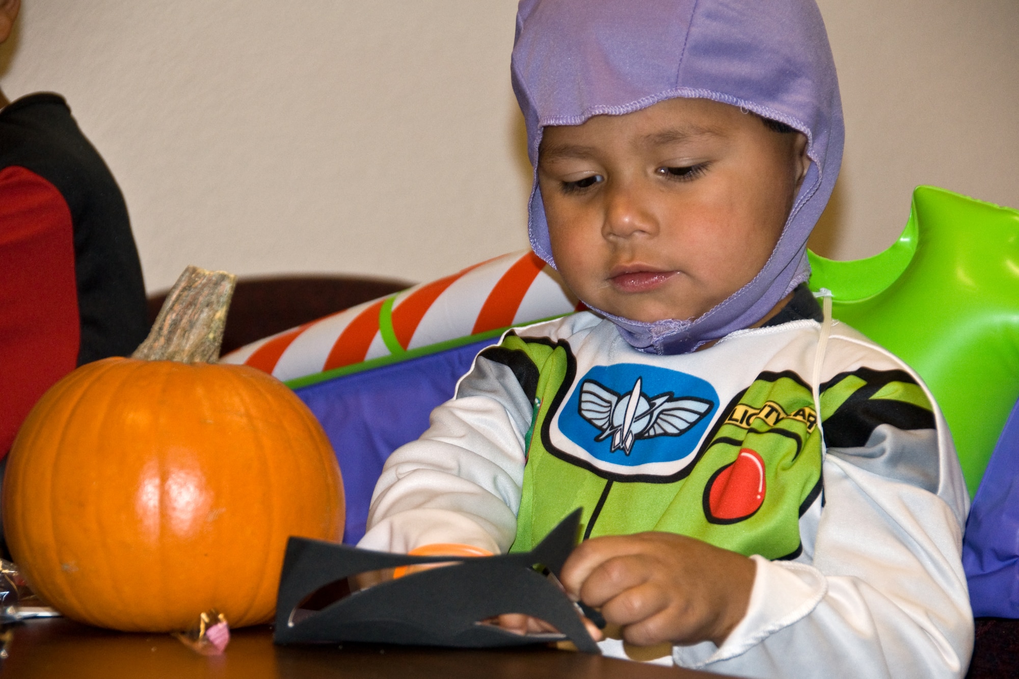 Victor Flores, son of Jose Flores, 60th Force Support Squadron manpower analyst, puts a face on a pumpkin at the AFRC special needs Halloween bash Oct. 27. (U.S. Air Force photo/ Airman 1st Class Joshua Crane)