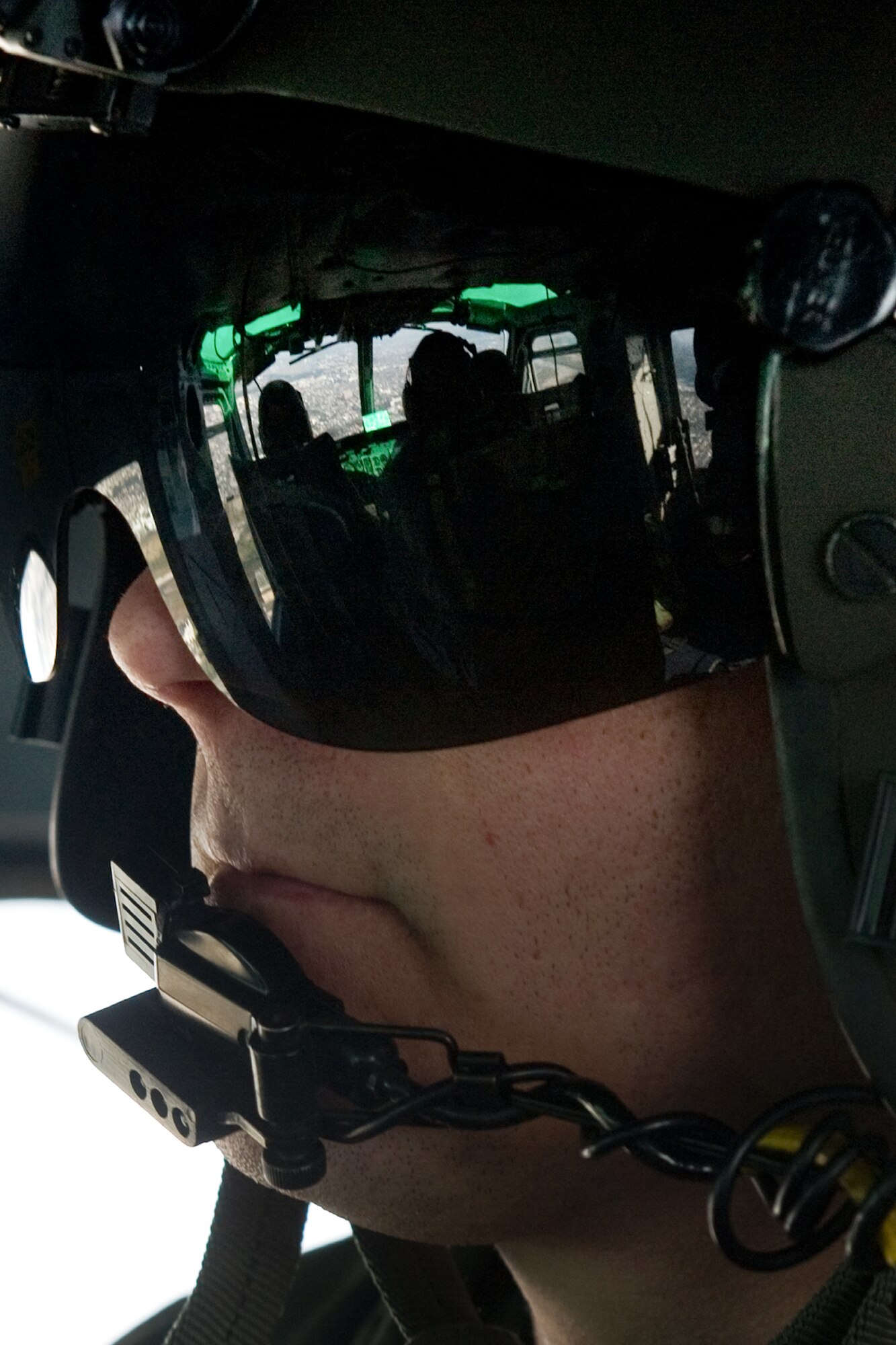 OVER JAPAN -- Tech. Sgt. Christopher Baker, 459th Airlift Squadron flight engineer, monitors UH-1 Huey flight progress Nov. 2, 2011 during the Samurai Surge. The Samurai Surge an all day flying exercise tested pilots from the 459th AS and 36th AS in several different areas. (U.S. Air Force photo/Osakabe Yasuo)