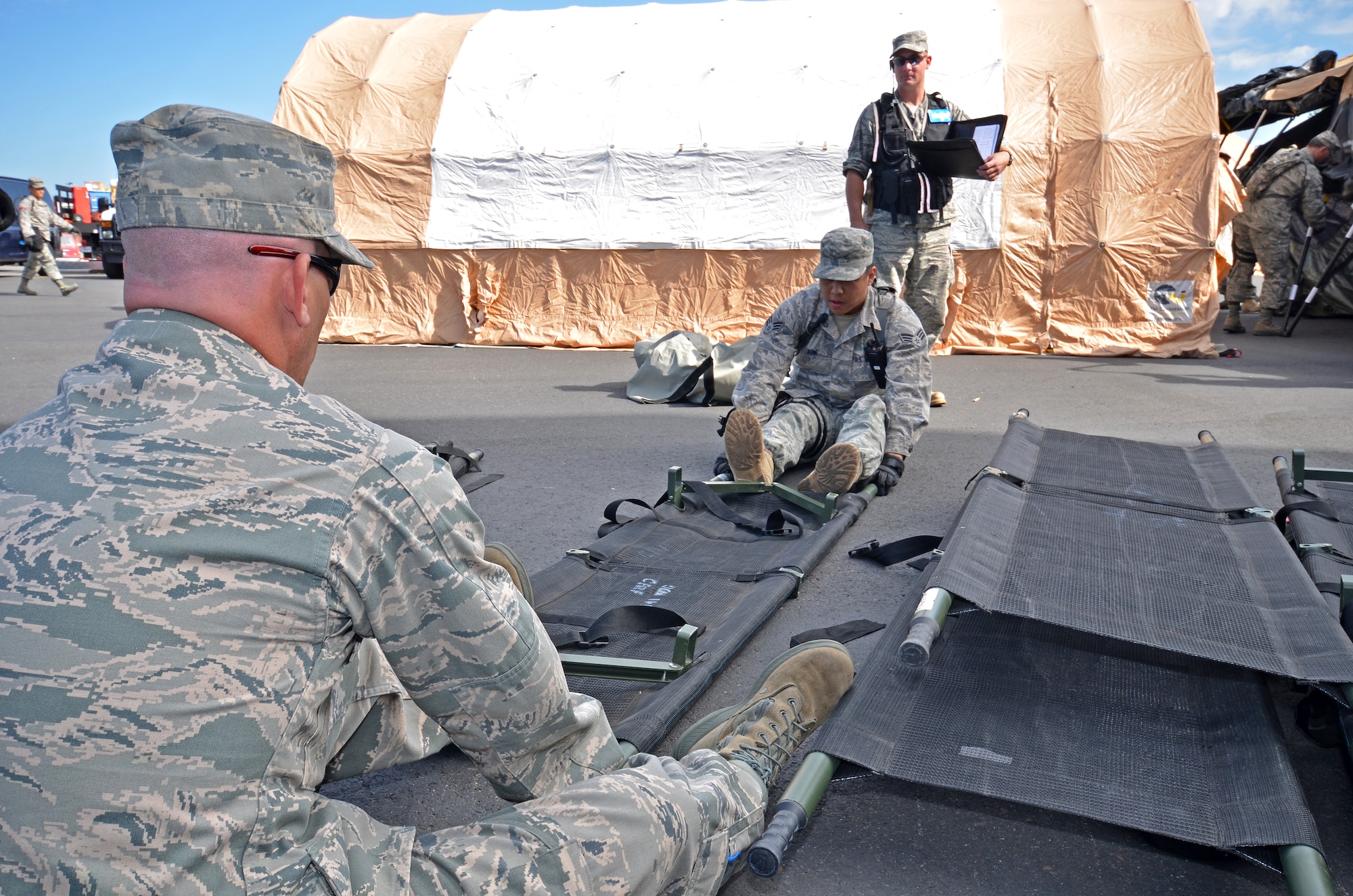 1 Lt. William Crandell (left) and Senior Airman Anthony Ahn from the 141st Medical Squadron prepare stretchers for patient transport during the HRF evaluation. (U.S. Air Force Photo by Staff Sgt. Anthony Ennamorato)