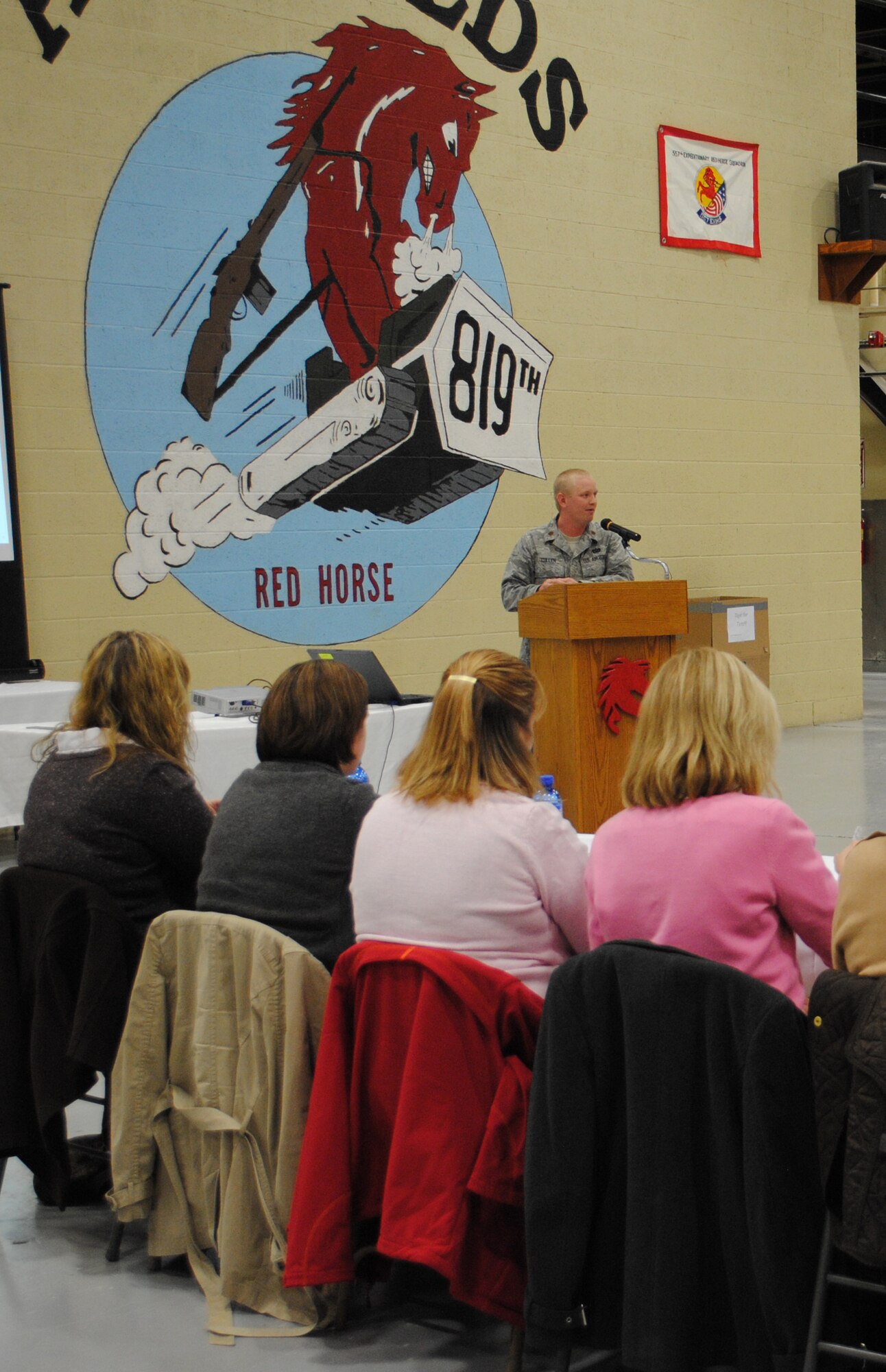 Members of Great Falls' CIVAIRES program listen to Maj. Andrew Cullen, 819th RED HORSE Squadron operations officer, as he gives the 819th RHS mission brief during a luncheon at the Airfields Hangar Nov. 1. For further photo coverage of the CIVAIRES members' RED HORSE orientation tour, see next week's Front Range Guardian. (U.S. Air Force photo/Airman Cortney Paxton)