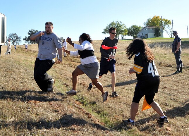 Bryan Hacker, left, dodges zombie Senior Airman Alisha Wyche of the 9th Forces Support Squadron, center, during the Zombie Run on October 31, 2011, at Candy Cane Park on Beale Air Force Base, Calif. More than 80 Airmen participated in the run , which was a first ever for Beale. (U.S. Air Force photo by Mr. Robert Scott/Released)