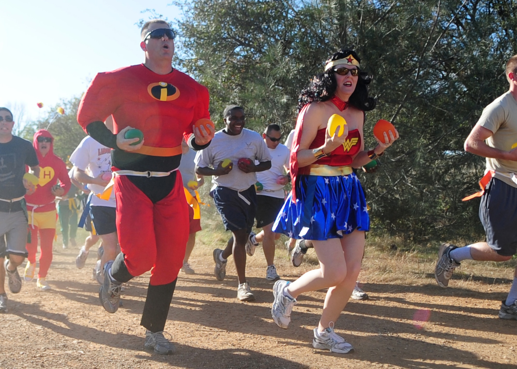 Tech Sgt. Latha Caillouette, dressed as Mr. Incredible, and his wife Tech. Sgt. Reagen Caillouette, 9th Civil Engineer Squadron, participate October 31, 2011, in the Zombie Run at Candy Cane Park at Beale Air Force Base, Calif. in celebration of Halloween. Each participant carried water balloons to douse zombies during the run, which was a first ever for Beale. (U.S. Air Force photo by Airman 1st Class Shawn Nickel/Released)