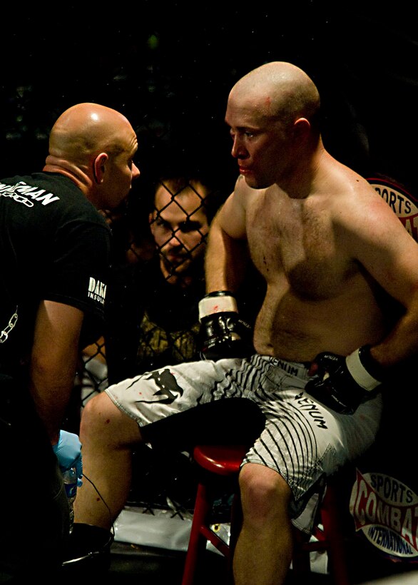 Prior to the second round, Jeremy Schunneman, Turner’s trainer, gives advice. (U.S. Air Force photo by Airman 1st Class Kate Thornton/Released)