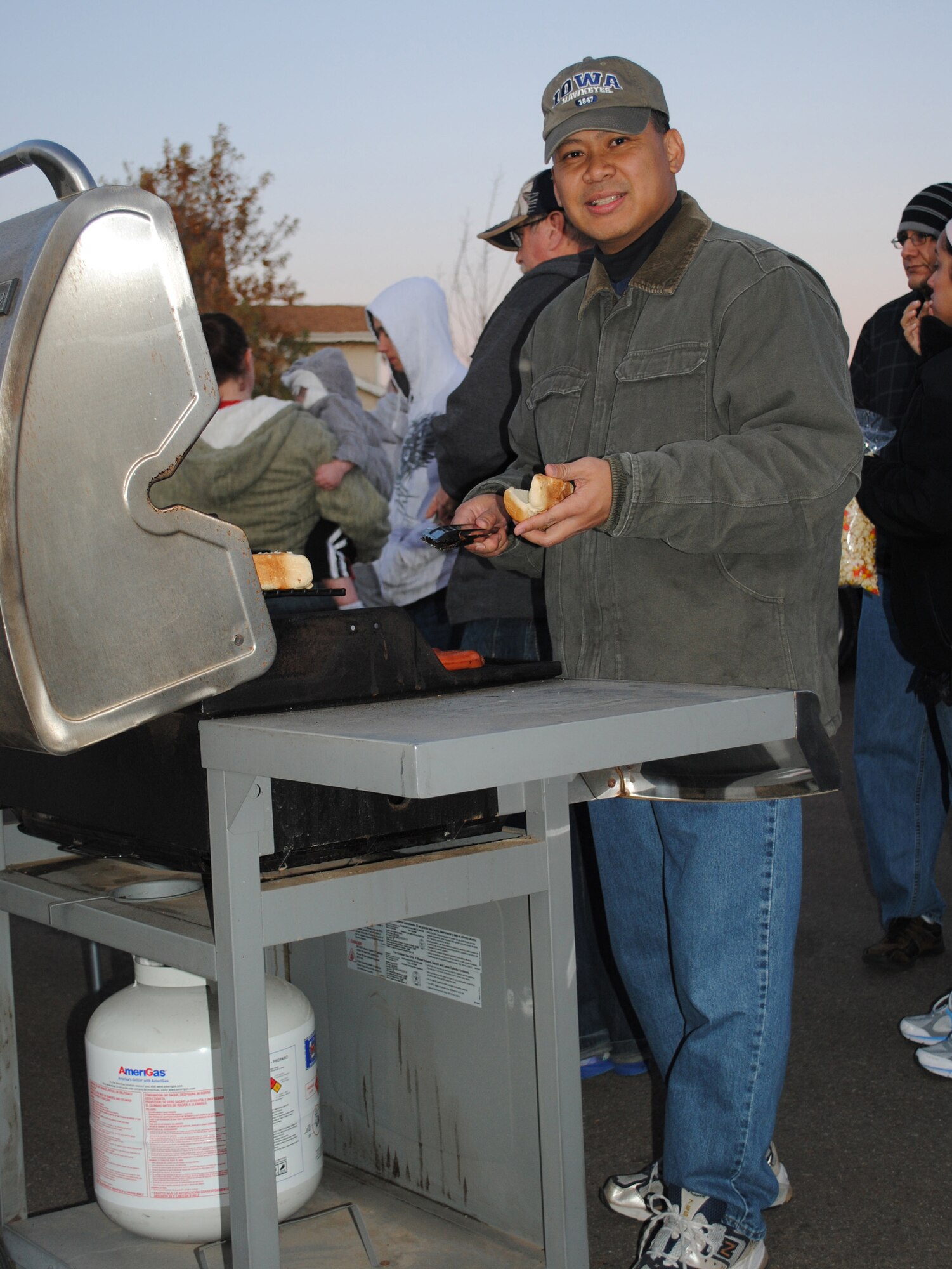Col. H.B. Brual, 341st Missile Wing commander, gets ready to serve a hot dog to a hungry trick-or-treater during the annual Halloween festivities at Malmstrom. (U.S. Air Force photo/Airman 1st Class Katrina Heikkinen)