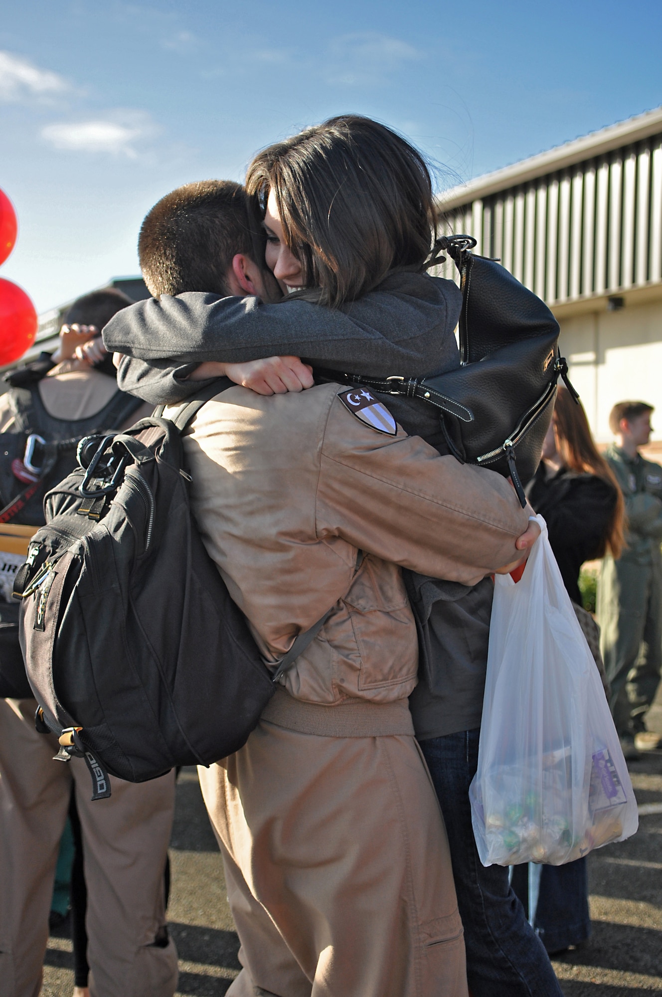 An 8th Airlift Squadron Airmen greets his wife after returning from a 67-day deployment in support of Operation Enduring Freedom, New Dawn and Combined Joint Task Force-Horn of Africa Nov. 3, 2011, at Joint Base Lewis-McChord, Wash. (U.S. Air Force photo/Airman 1st Class Leah Young)