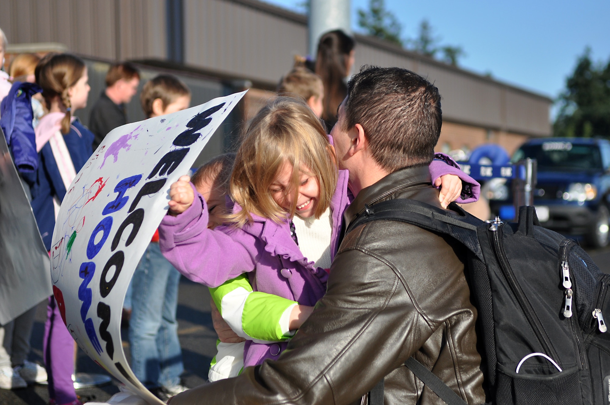 Capt. Evan Nickel, 8th Airlift Squadron pilot, embraces his children, Eliana and Ezekiel, after returning from a 67-day deployment Nov. 3, 2011, at Joint Base Lewis-McChord, Wash. In addition to routine deployment missions, the team also executed five short-notice distinguished visitor missions, including moving the Chairman of the Joint Chiefs of Staff and the President's Deputy National Security Advisor for Afghanistan to Pakistan for a meeting with the Prime Minister. (U.S. Air Force photo/Airman 1st Class Leah Young)