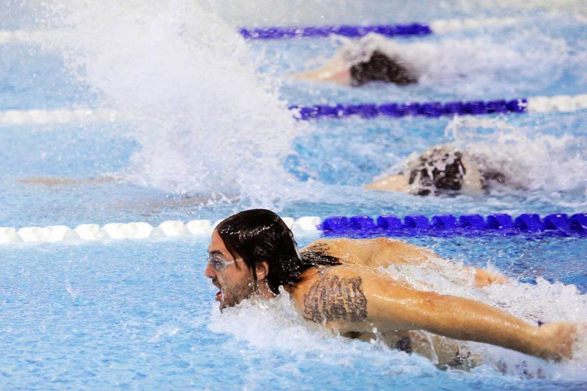 ABOVE: Matt Oberlander (bottom) keeps pace with Kenneth Cummings and Josh Bowen (top) in the men’s 100-yard individual medley. The three swimmers were almost as close at the finish line, with Oberlander in first at 59.33 seconds, followed by Cummings at 1.02 and Bowen at 1.03. Oberlander swam for the 673d FSS, while Cummings swam for the 4th Brigade Combat Team (Airborne), 25th Infantry Division, and Bowen for A Company, 3rd Battalion, 509th Infantry Regiment (Airborne). (U.S. Air Force photo/John Pennell)