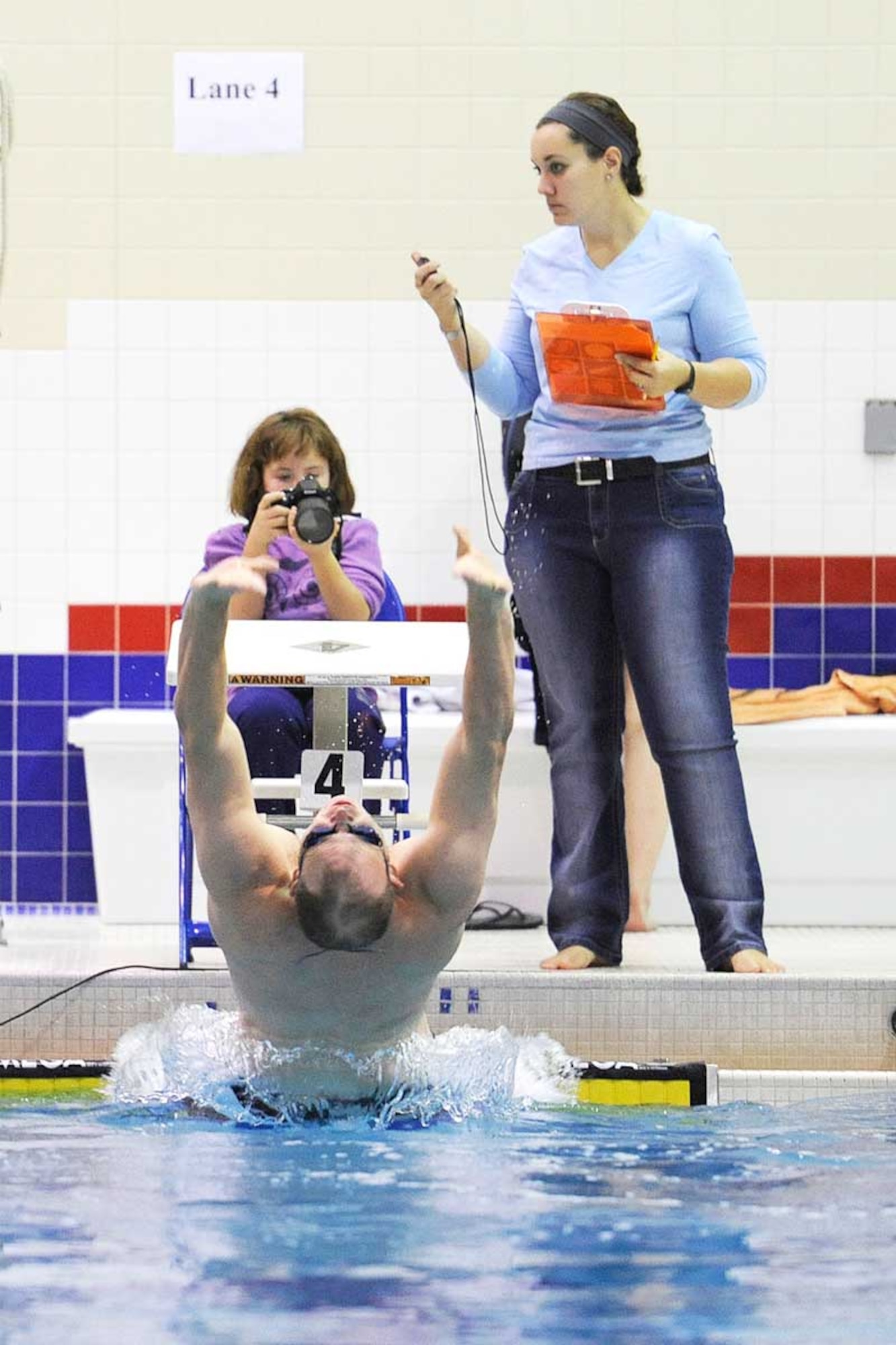 Kenneth Cummings blasts away from the wall at the start of the men’s 50-yard backstroke. Cummings, swimming for the 4-25th ABCT, won the event with a time of 28.78 seconds. (U.S. Air Force photo/John Pennell)