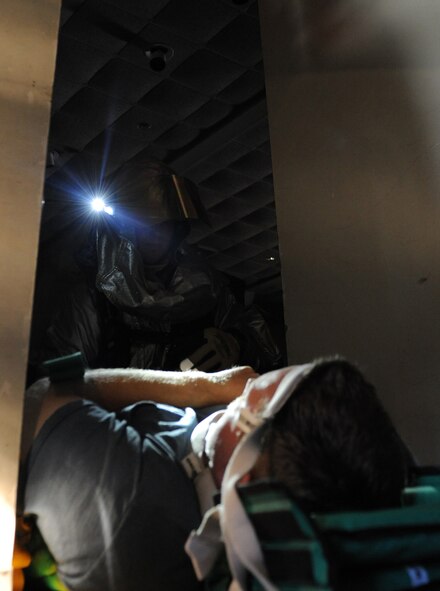 A fire-fighter from the 2nd Civil Engineer Squadron secures a simulated tornado victim to a stretcher during a Major Accident Response Exercise on Barksdale Air Force Base, La., Nov. 1. Once secured, the simulated victim was carried out of the building for medical treatment. (U.S. Air Force photo/Airman 1st Class Micaiah Anthony)(RELEASED)