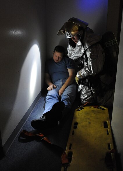 A fire-fighter from the 2nd Civil Engineer Squadron finds a simulated tornado victim during a Major Accident Response Exercise on Barksdale Air Force Base, La., Nov. 1. Fire-fighters had to wait for the building's power to be turned off before they could enter. (U.S. Air Force photo/Airman 1st Class Micaiah Anthony)(RELEASED)