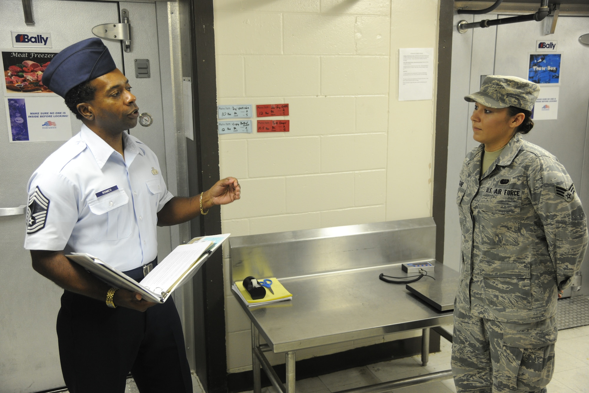 U.S. Air Force Chief Master Sgt. Joe Romeo, 
Air Combat Command services functional manager, inspects Senior Airman Renae Gore, 23rd Force Support Squadron stock room manager, at the Georgia Pines Dining Facility, Moody Air Force Base, Ga., Nov. 1, 2011. The ACC inspection team asked questions and inspected on categories consisting of job procedures, budgeting, food quality and service. (U.S. Air Force photo by Airman 1st Class Paul Francis/Released) 
