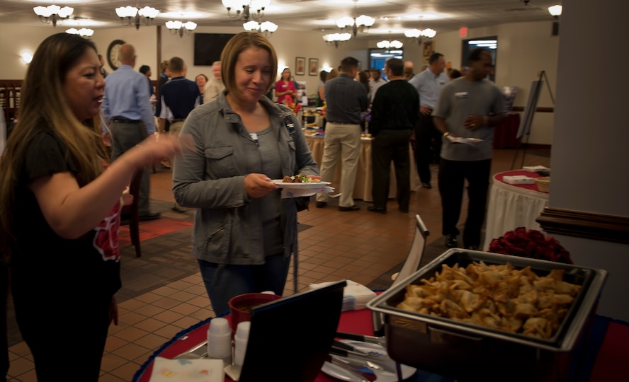 U.S. Air Force Master Sgt. Shiela Leick, 23rd Force Support Squadron, left, shows Senior Master Sgt. Rosa Aumack, Air Combat Command food services management, the various foods prepared for an ice breaker event at Moody Air Force Base, Ga., Oct. 30, 2011. Aumack was part of an ACC Hennessy team who inspected the Georgia Pines Dining Facility and Flight Kitchen. (U.S. Air Force photo by Airman 1st Class Nicholas Benroth/Released)