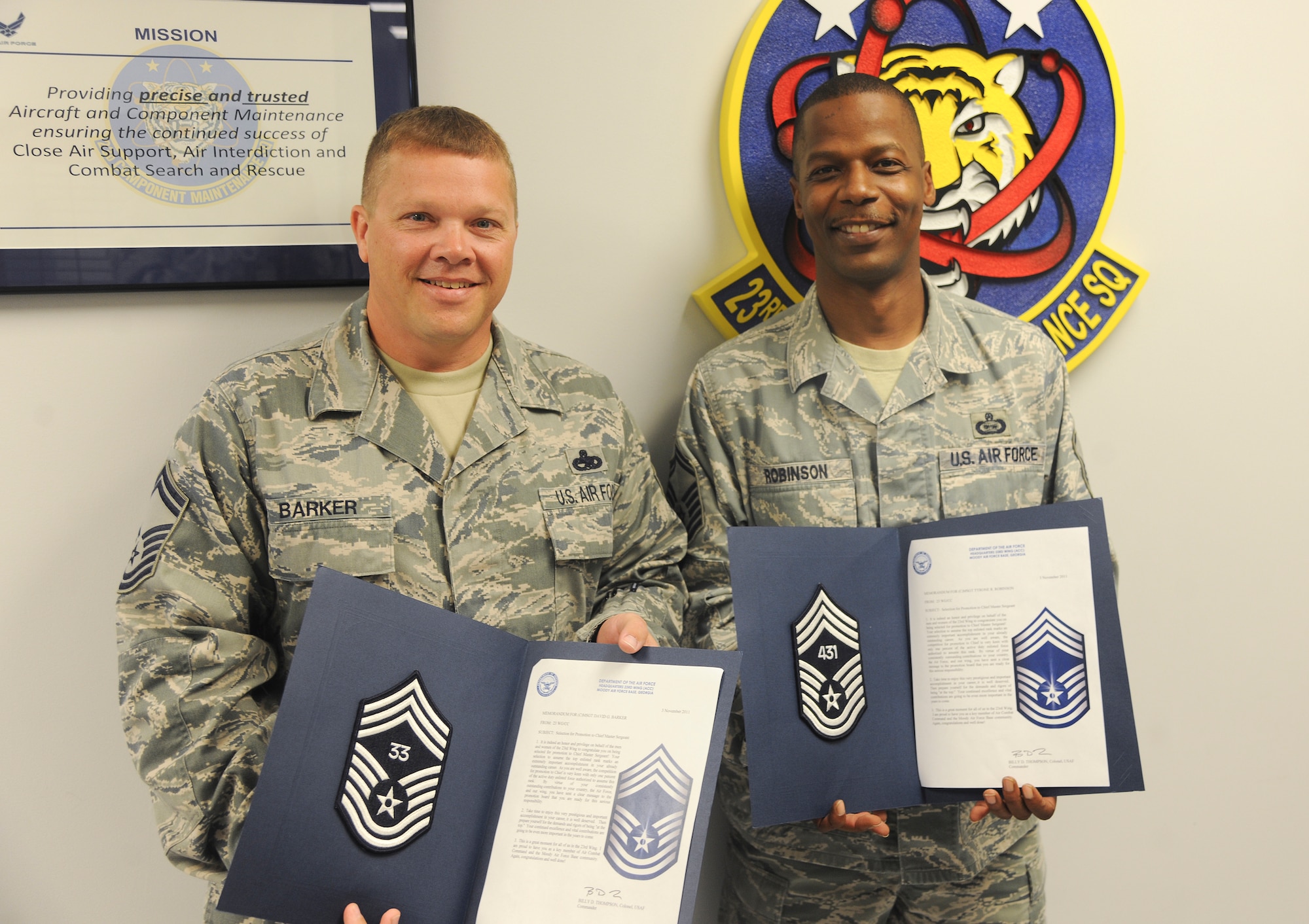 U.S. Air Force Senior Master Sgts. David Barker, 23rd Component Maintenance Squadron lead production superintendent, left, and Tyrone Robinson, 93d Air Ground Operations Wing intelligence superintendent, show off their promotion selection certificates at Moody Air Force Base, Ga., Nov. 3, 2011. Both chief master sergeant selects were notified of their promotion by Col. Billy Thompson, 23rd Wing commander, and Chief Master Sgt. Frank Batten, 23rd Wing command chief. (U.S. Air Force photo by Airman 1st Class Paul Francis/Released) 
