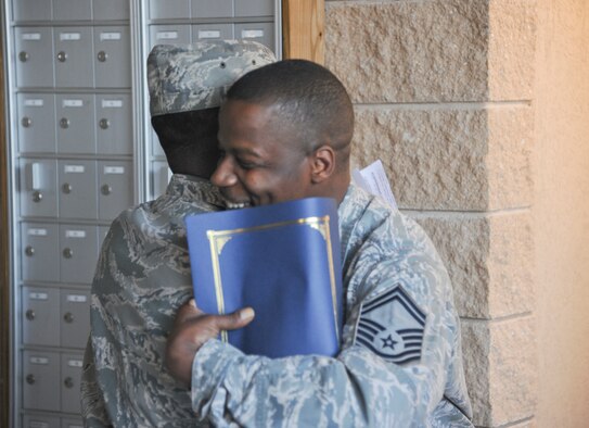 U.S. Air Force Chief Master Sgt. Gregory Brown, 23rd Fighter Group superintendent, congratulates Senior Master Sgt. Tyrone Robinson, 93d Air Ground Operations Wing intelligence superintendent, on his selection for chief master sergeant at Moody Air Force Base, Ga., Nov. 3, 2011. It was Robinson’s first attempt in making the new rank. (U.S. Air Force photo by Airman 1st Class Paul Francis/Released)
