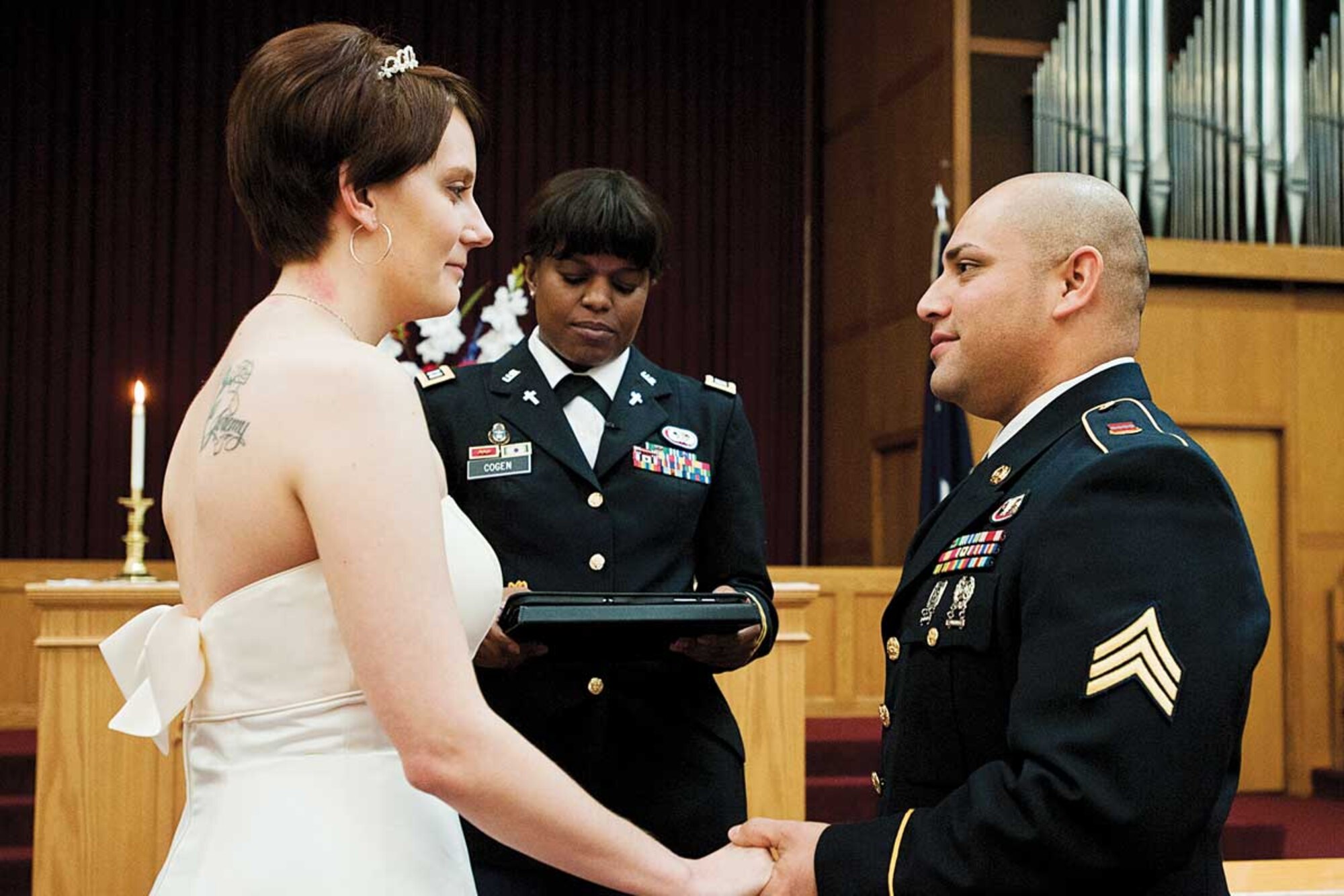 Sgt. Victor Arias, 725th Brigade Support Battalion transportation technician, and Sara, his wife, renew their wedding vows at the Soldier’s Chapel on Joint Base Elmendorf-Richardson October 27.  Six couples took part in the renewal of their vows, led by Army Chaplain (Capt.) Cogen, 725th BSB chaplain. (U.S. Air Force photo/Staff Sgt. Zachary Wolf)