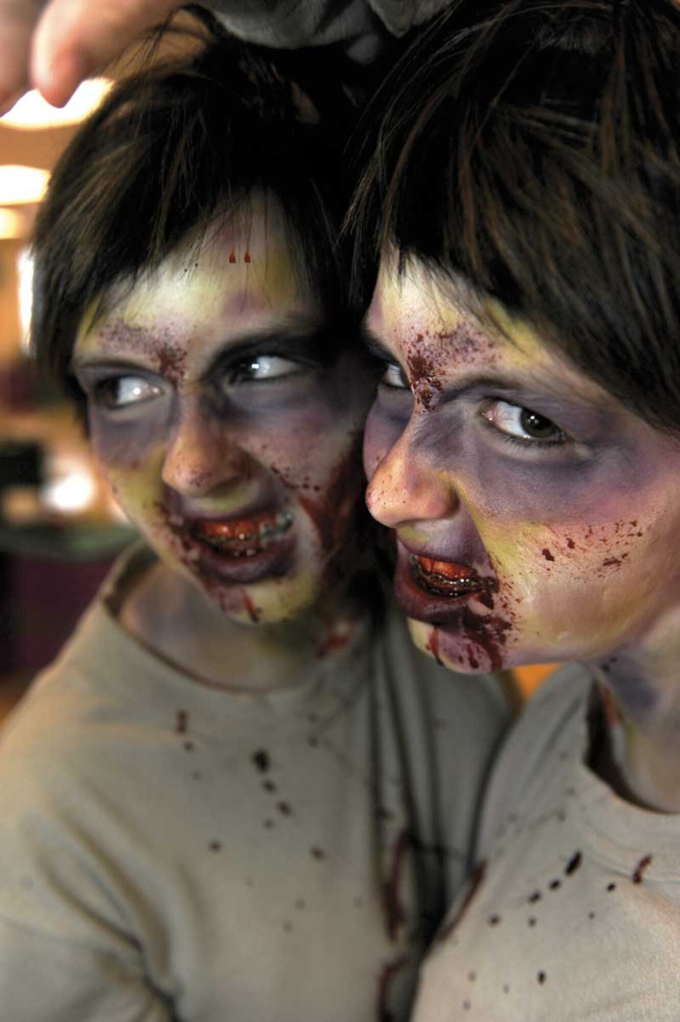 Airman 1st Class Alannah Holbrook tests the realism of the moulage work during a simulated zombie invasion in the Joint Base Elmendorf-Richardson Fitness Center on Halloween.  (U.S. Air Force photo/Staff Sgt. Robert Barnett)