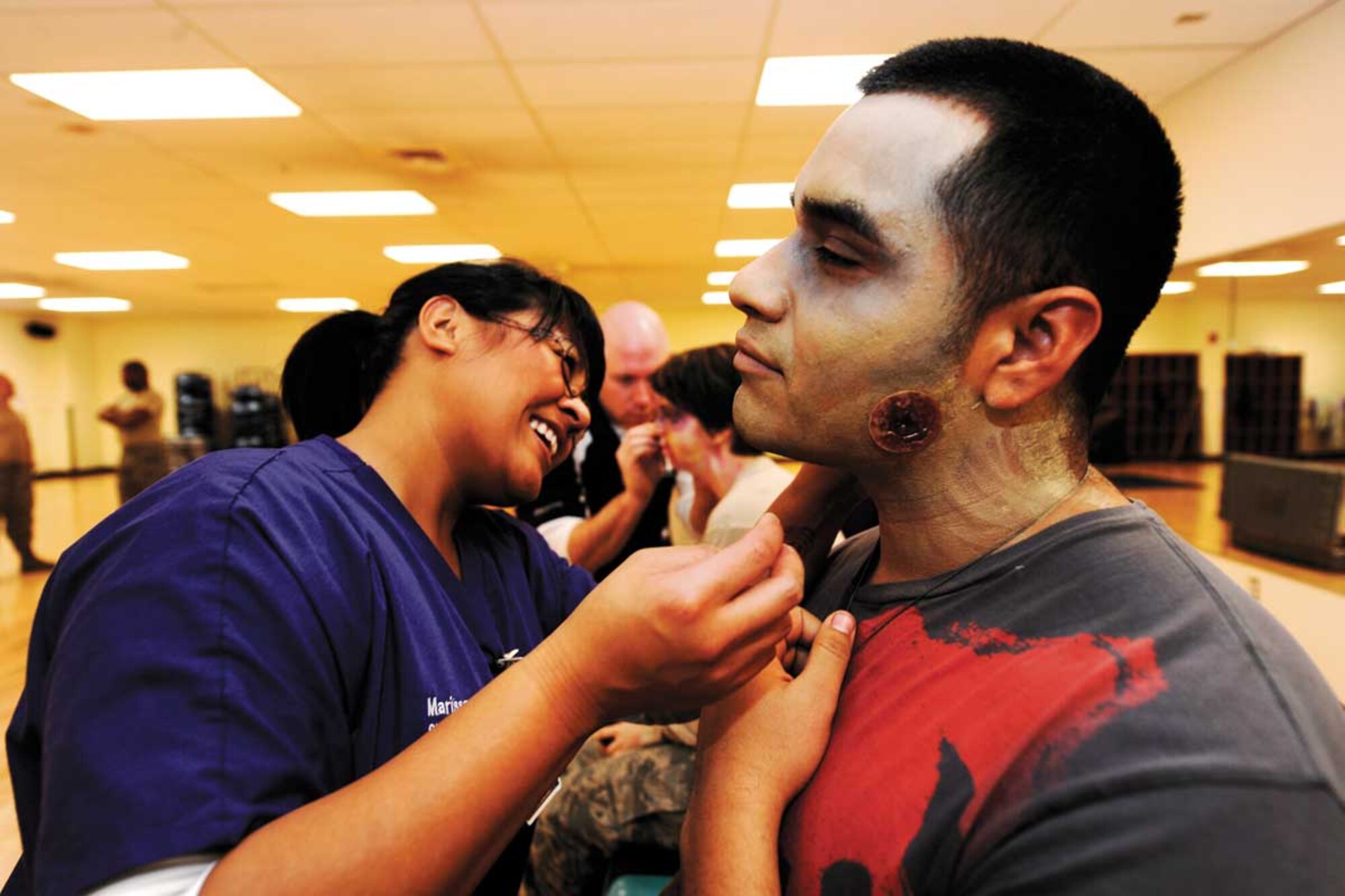 Moulage team members from Joint Base Elmendorf-Richardson hospital’s Simulation Center and the University of Alaska in Anchorage use their skills and talents to visually turn volunteers into zombies at the JBER Fitness Center Monday. The moulage team partners with off-base organizations to enhance community relations by working together to create realistic scenarios. The Simulation Center normally works on mass-casualty scenes for the base emergency services to respond to, and for physicians to practice on. (U.S. Air Force photo/Staff Sgt. Robert Barnett)