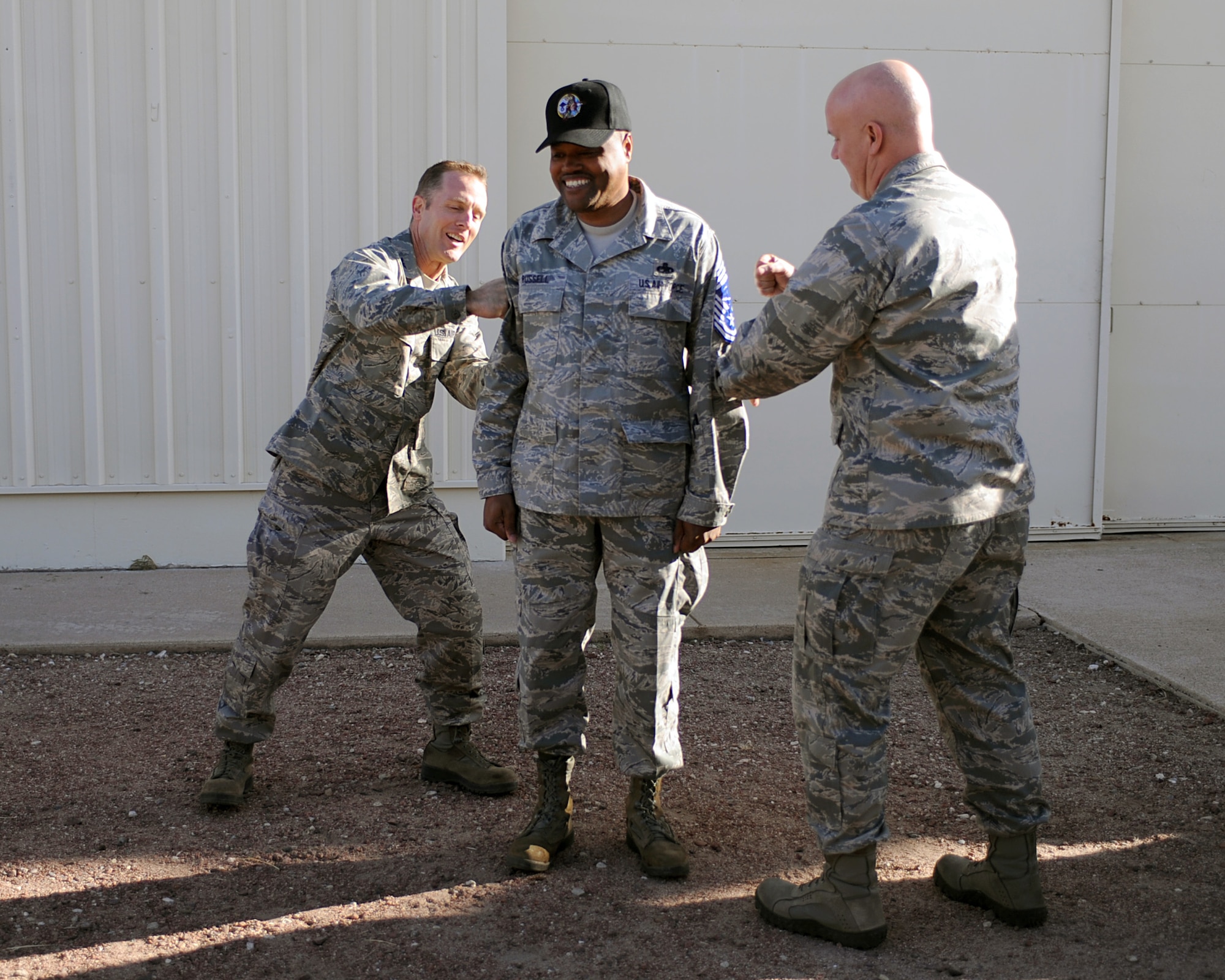 U.S. Air Force Col. John Cherrey, 355th Fighter Wing commander, and Col. Mark Murphy, 355th Maintenance Group commander, tack chief master sergeant stripes on selectee Senior Master Sgt. John Russell, 355th Aircraft Maintenance Squadron, on Davis-Monthan Air Force Base, Ariz. Nov. 3, 2011. Out of the 487 senior master sergeants promoted to Chief Air Force-wide, eight of them were members of the Desert Lightning Team. (U.S. Air Force photo by Airman 1st Class Christine Griffiths)