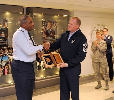 Chief Master Sgt. James Cody, the command chief of Air Education and Training Command, congratulates Maj. Gen. Alfred Flowers, the deputy assistant secretary for budget for the Assistant Secretary of the Air Force for Financial Management and Comptroller office, on his selection as an AETC Order of the Sword recipient. Cody announced the general's selection during a brief ceremony at the Pentagon's Airman's Hall on Nov. 2. (U.S. Air Force photo/Andy Morataya)