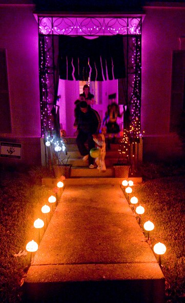 Costumed children visit a decorated house to receive candy Halloween night on Barksdale Air Force Base, La. From 6 p.m. until 8 p.m. on Oct. 31, base-housing areas were open to Barksdale Airmen and their families for trick or treating. (U.S. Air Force photo/Senior Airman Chad Warren)(RELEASED)