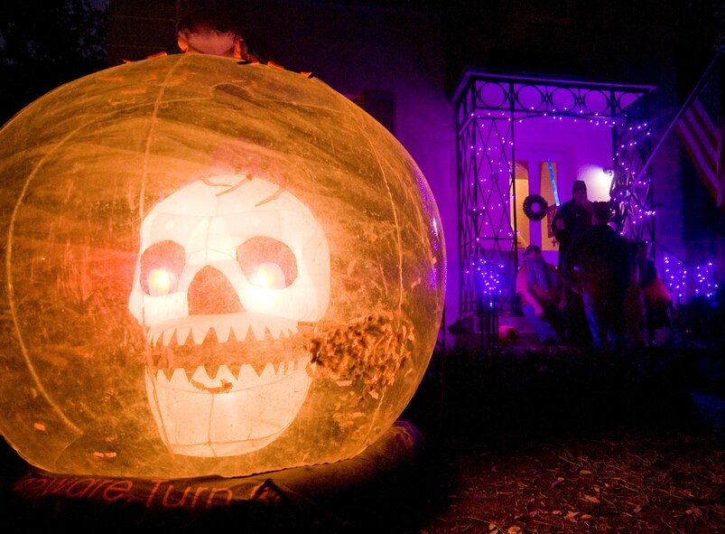 Barksdale Air Force Base residents offer candy to costumed children from their porch Halloween night on Barksdale Air Force Base, La., Oct 31. Many residents of base-housing decorate their homes and yards for this annual event. (U.S. Air Force photo/Senior Airman Chad Warren)(RELEASED)