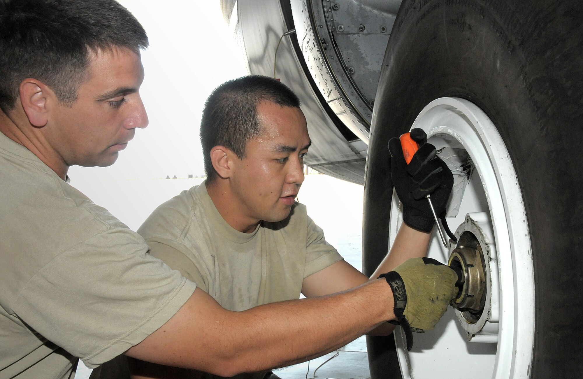 Airman 1st Class Joseph Ray A. Perez assists with changing a tire on a C130-J during a maintenance training exercise with other members of the 146th Aerospace Maintenance Squadron at the 146th Airlift Wing Port Hueneme, Calif. on October 2, 2011. Airman 1st Class Perez is the 146th Airlift Wing's Featured Airman of the Month for October 2011.