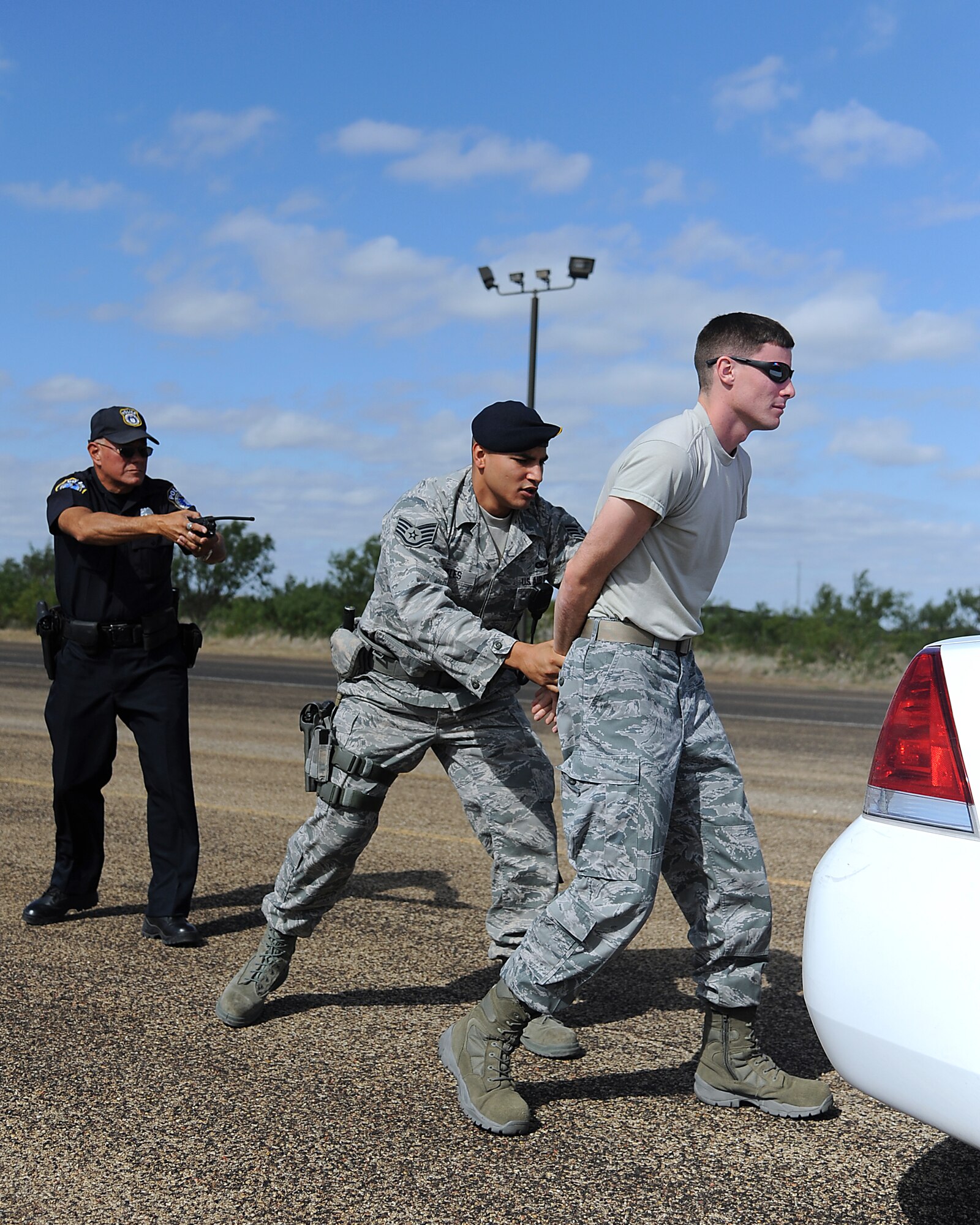 GOODFELLOW AIR FORCE BASE, Texas – Staff Sgt. Joseph Rosales, 17th Security Forces Squadron, places Senior Airman Jeremy Davis, 17th SFS, "under arrest" during an exercise here Oct. 6. In order to maintain and ensure operational readiness the SFS members conduct random situational exercises typical to what they may encounter on a day to day basis. (U.S. Air Force photo/Airman 1st Class Michael Smith)