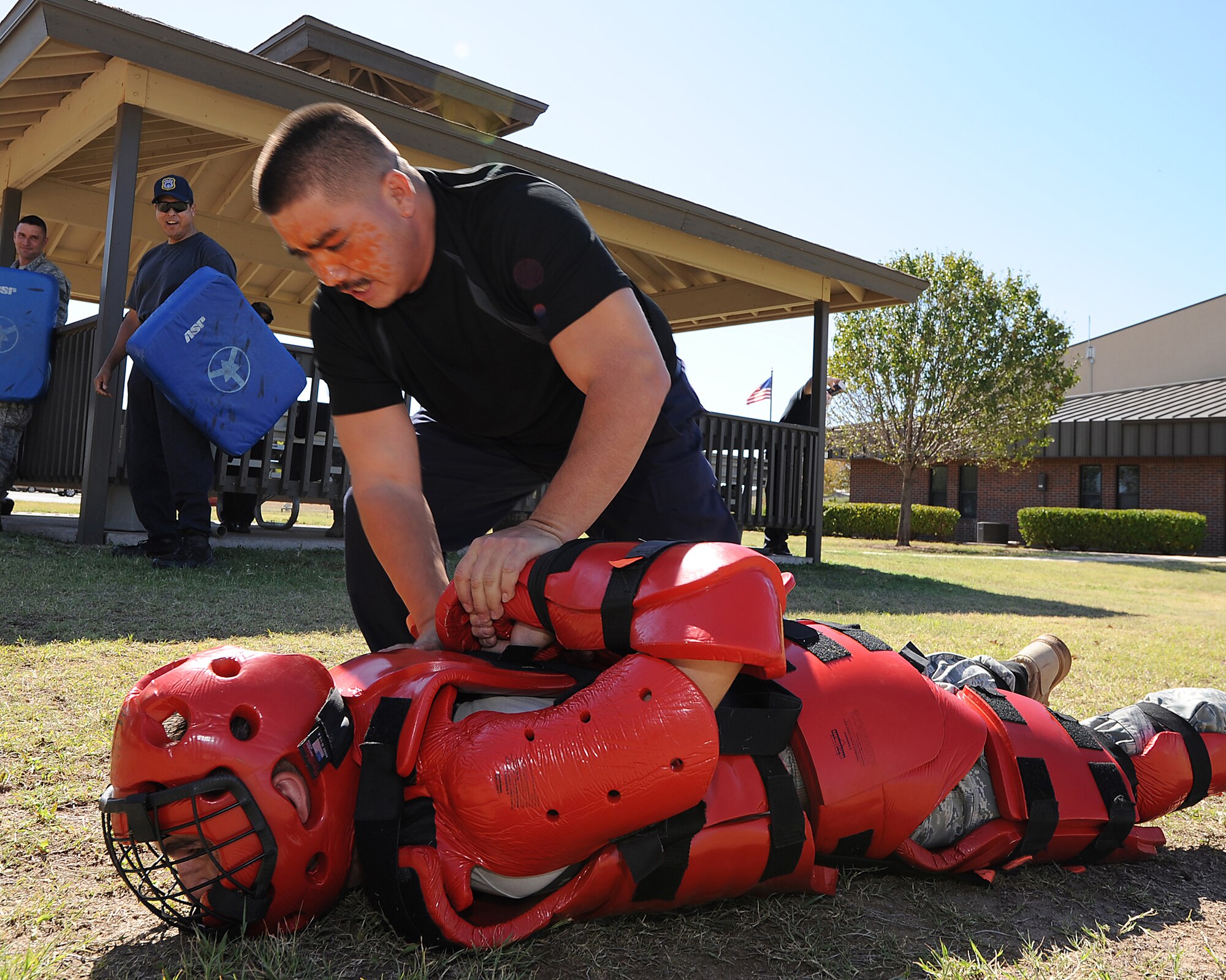 GOODFELLOW AIR FORCE BASE, Texas – Officer Robert Torres, 17th Security Forces Squadron, places Staff Sgt. Jonathan Keough, 17th SFS, "under arrest" after getting a face full of pepper spray Oct. 12. Each member of 17th SFS gets pepper sprayed to prepare them to keep calm and remember their training in a worst case scenario. (U.S. Air Force photo/Airman 1st Class Michael Smith)