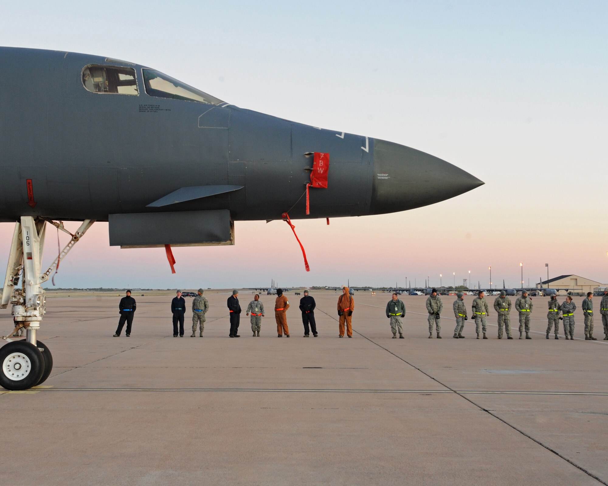 Dyess airmen line up to participate in a Foreign Object Debris walk Nov. 3, 2011, at Dyess Air Force Base, Texas. Examples of FOD are aircraft parts, rocks, broken pavement, ramp equipment, tools, bolts and vehicle parts. (U.S. Air Force photo by Airman 1st Class Peter Thompson/Released)