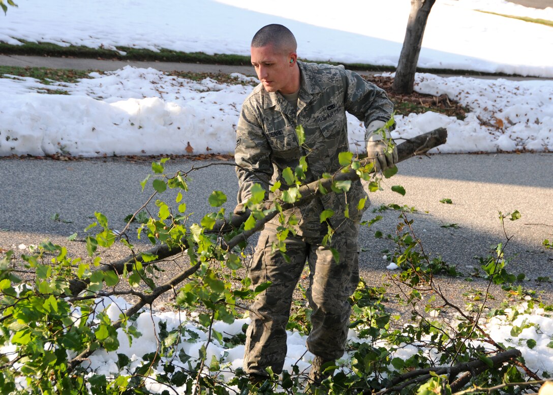 Airman 1st Class Israel Rosario from the 104th Fighter Wing, Westfield Mass., removes debris from a road in Westfield,  Mass., on Tue, November 2, 2011 while working with the Hampden DPW .  He and more than 50 saw-teams were activated to support clean-up efforts in the state following the unusual snow storm that hit the eastern seaboard Oct 29-30th 2011. (photograph by Technical Sgt. Melanie J. Casineau)