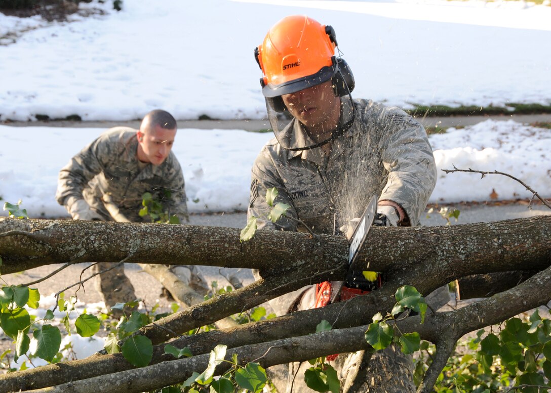 Staff Sgt. Sean Dowd from the 104th Fighter Wing, Westfield Mass., cuts a tree apart in an effort to clear a road in Westfield,  Mass., on Tue, November 2, 2011 while working with the Hampden DPW .  He and more than 50 saw-teams were activated to support clean-up efforts in the state following the unusual snow storm that hit the eastern seaboard Oct 29-30th 2011. (photograph by Technical Sgt. Melanie J. Casineau)