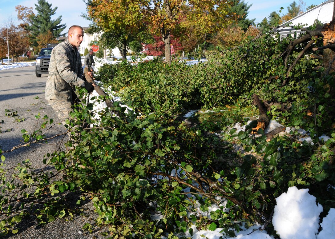 Airman 1st Class Israel Rosario from the 104th Fighter Wing, Westfield Mass., removes debris from a  road in Westfield,  Mass., on Tue, November 2, 2011 while working with the Hampden DPW .  He and more than 50 saw-teams were activated to support clean-up efforts in the state following the unusual snow storm that hit the eastern seaboard Oct 29-30th 2011. (photograph by Technical Sgt. Melanie J. Casineau)
