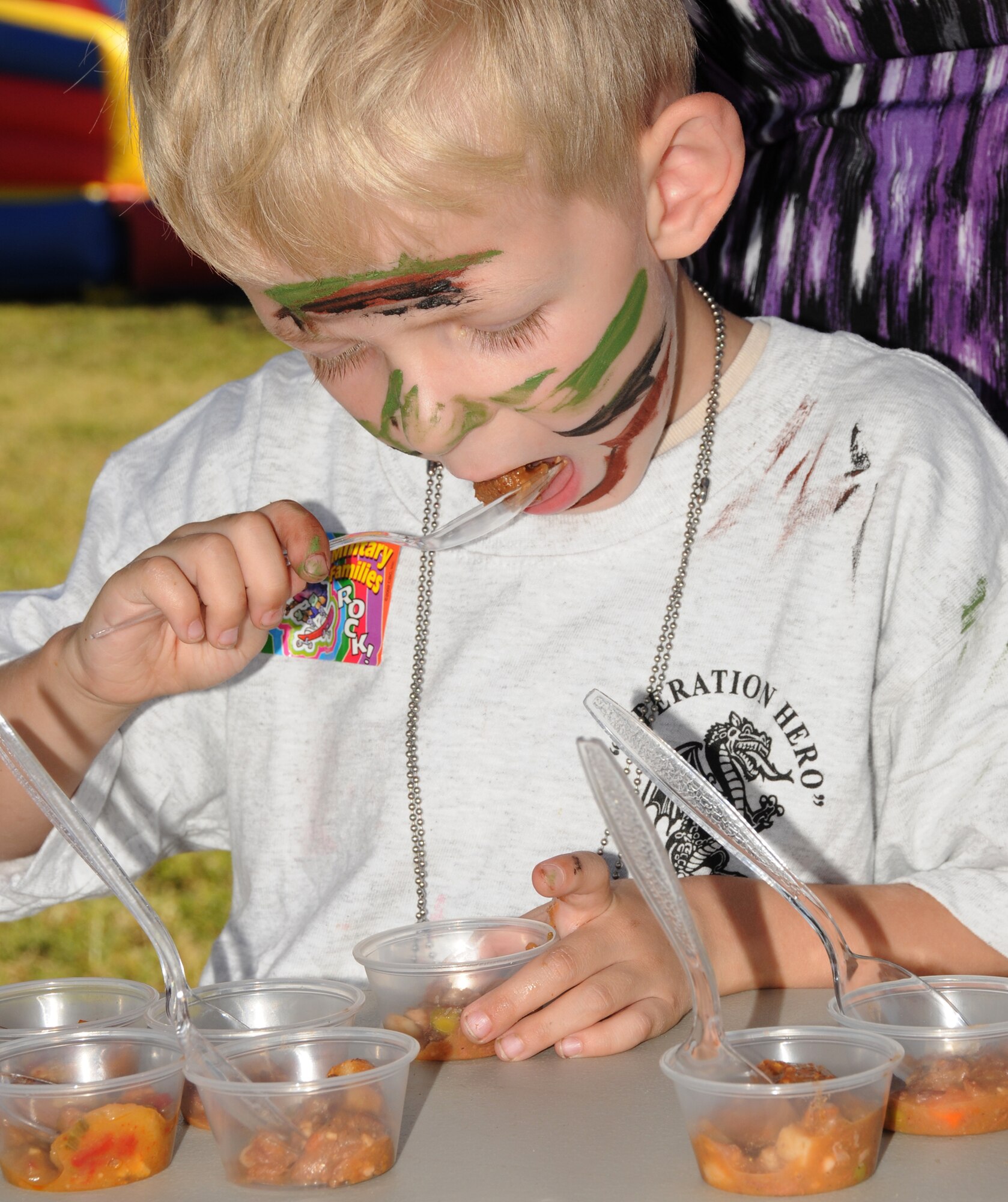 Andrew Smith,  5, samples a pot roast from a Meals Ready to Eat package during Operation Hero Oct. 15, 2011, Keesler Air Force Base, Miss.  Andrew is the son of 2nd Lt. Brian and Renee Smith, 85th Engineering Installation Squadron.  Operation Hero is presented twice a year to give parents a chance to expose their children to what happens when they leave home for deployment tasking or temporary duty.   (U.S. Air Force photo by Kemberly Groue)