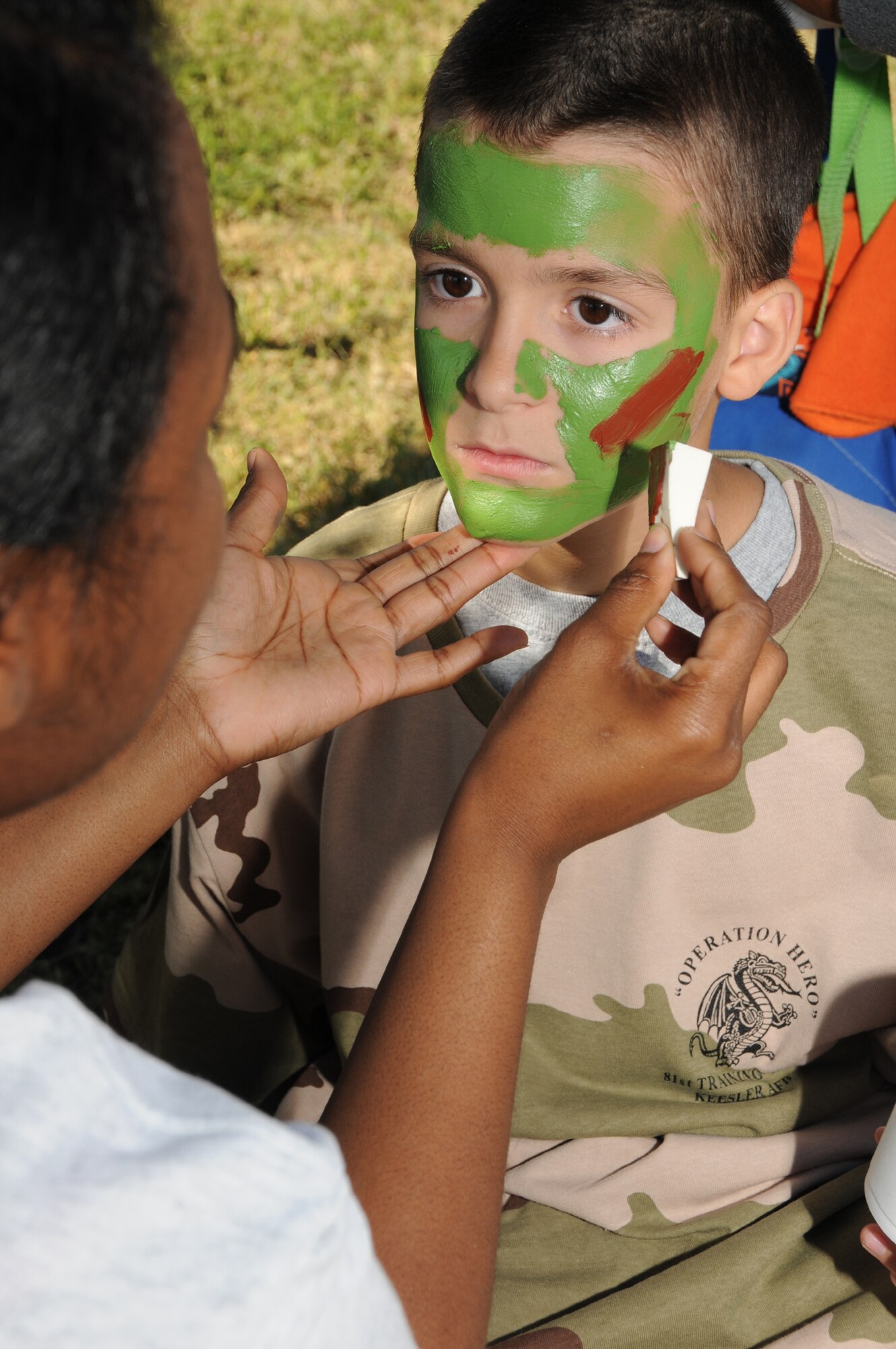 Senior Airman Nicole Rambert, 81st Medical Operations Squadron, paints the face of Brenden Romkey, 11, son of Master Sgt. Gary and Debbie Romkey, 335th Training Squadron, during Operation Hero Oct. 15, 2011, Keesler Air Force Base, Miss.  MSgt Romkey is currently deployed to Kirkystan.  Operation Hero is presented twice a year to give parents a chance to expose their children to what happens when they leave home for deployment tasking or temporary duty.  (U.S. Air Force photo by Kemberly Groue)