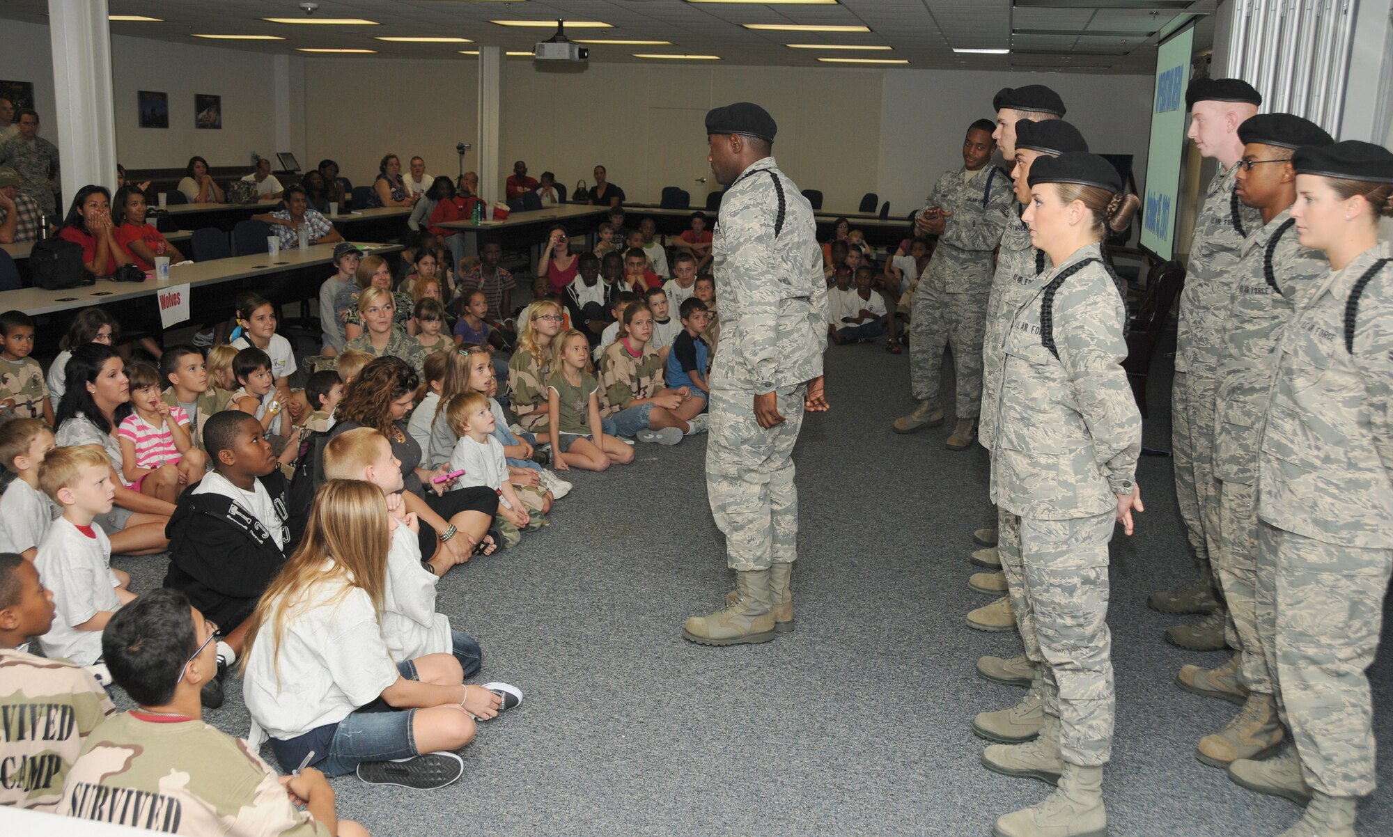 Members of the 338th Training Squadron drill team give a performance during Operation Hero Oct. 15, 2011, at the Sablich Center, Keesler Air Force Base, Miss.  Operation Hero is presented twice a year to give parents a chance to expose their children to what happens when they leave home for deployment taskings or temporary duty.  (U.S. Air Force photo by Kemberly Groue)