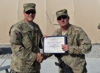 Staff Sgt. Rodney Isbell (right), 567th RED HORSE, receives the NCO of the Month award from the commander of the 809th Expeditionary RED HORSE. (USAF photo courtesy of 567RHS)