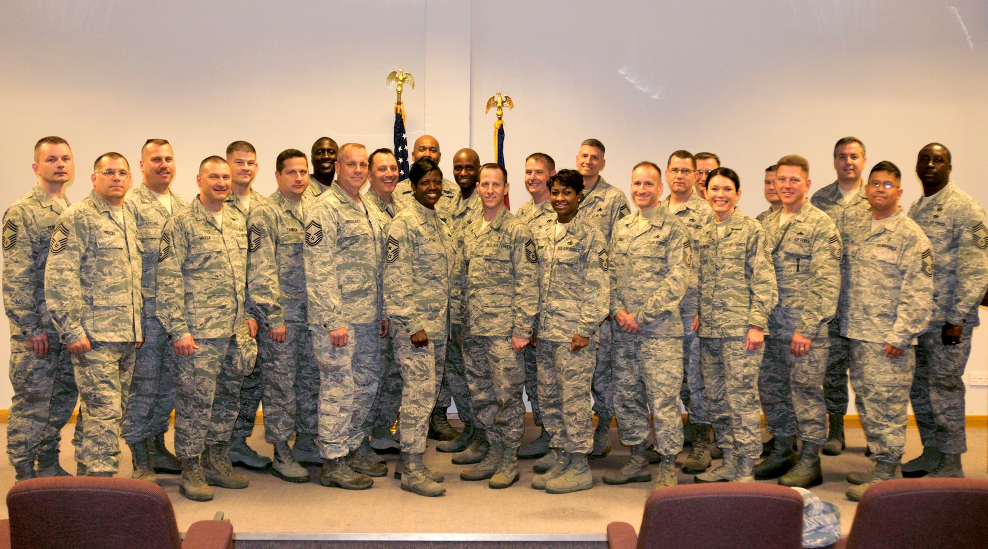 ROYAL AIR FORCE LAKENHEATH, England - Members from the Chief's group stand with the Liberty Wing's newest Chief selects at the Strike Eagle Complex, Nov. 3, 2011. Eight seniormaster sergeants were surprised with news of their promotion today by the chiefs along with other base leadership. (U.S. Air Force photo by Senior Airman Tiffany M. Deuel)
