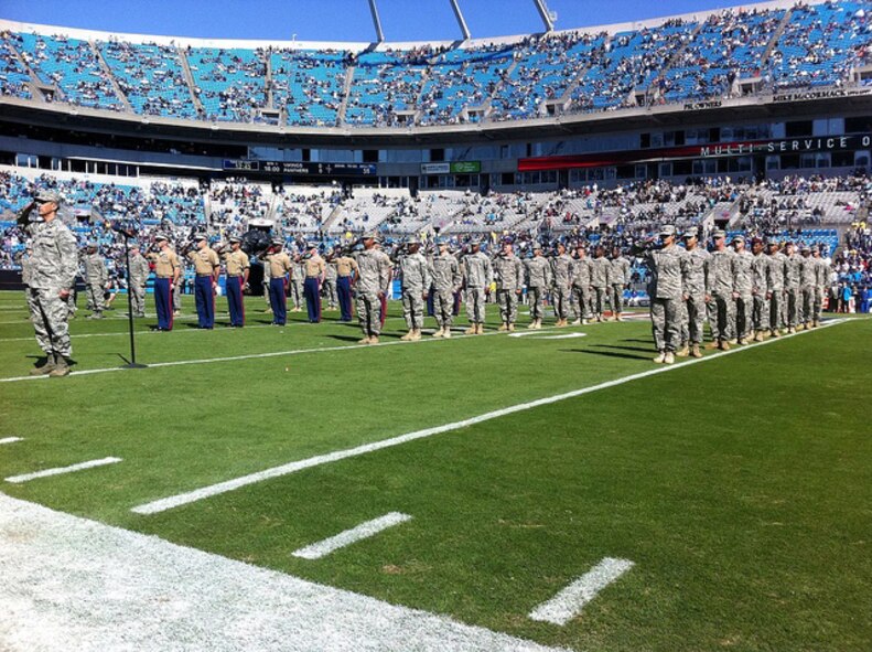 Col. Randy Ogden, 916th Air Refueling Wing commander, stands in front of military members from the Army, Navy, Air Force, Marines, Coast Guard, Reserve and Guard forces who re-enlisted at the Carolina Panthers game on Oct. 30, 2011. Col. Ogden gave the oath of enlistment. (USAF photo by SSgt. Kyle Richardson, NCNG)