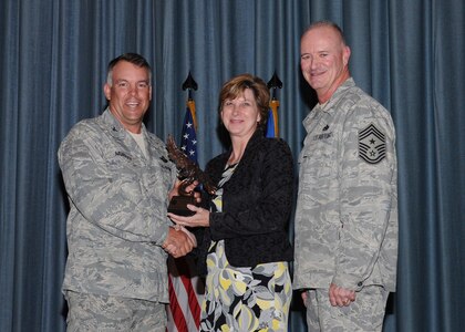 Col. Richard Murphy, 12th Flying Training Wing Commander, and Chief Master Sgt. Steven Jones, 12th FTW command chief, presents Deborah Aguirre with the Civilian Supervisor Category II of the Quarter award during the Joint Base San Antonio Randolph 3rd Quarter Award Ceremony at the base theater at Randolph Air Force Base, Texas, Nov. 2.(U.S. Air Force photo/Melissa Peterson)